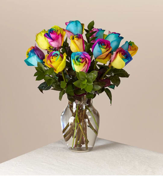 Rainbow Rose Bouquet - There is no more magical, natural occurrence than a rainbow - have it be in the sky or in a fresh floral arrangement. Our bouquet of a dozen hand-dyed roses symbolizes the majestic phenomenon, with its brilliant colors in each bloom.  One dozen rainbow roses are about 13"H by 13"W.