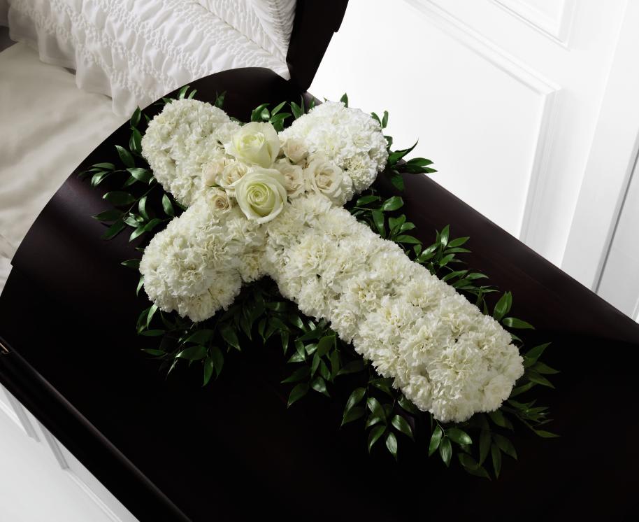 FTD Peaceful Memories Casket Spray - The FTD Peaceful Memories Casket Spray is a gorgeous way to   commemorate the faith and devotion of the deceased. White carnations are   arranged in the shape of a cross accented in the middle with white   roses and spray roses and along the sides with lush greens to create a   lovely casket spray that brings peace and solace to those that attend   their final farewell.      31""h x 22""w