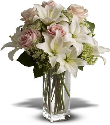 Heavenly and Harmony - Stunning in its simplicity, this innocent harmony of light pink roses and snow white lilies are a heartfelt way to send your very best. The classic, clear rectangular glass vase keeps the focus on the heavenly beauty of the blooms.  Light pink roses and white asiatic lilies form a fragrant bouquet with delicate touches of Queen Anne's lace and rich green salal. 