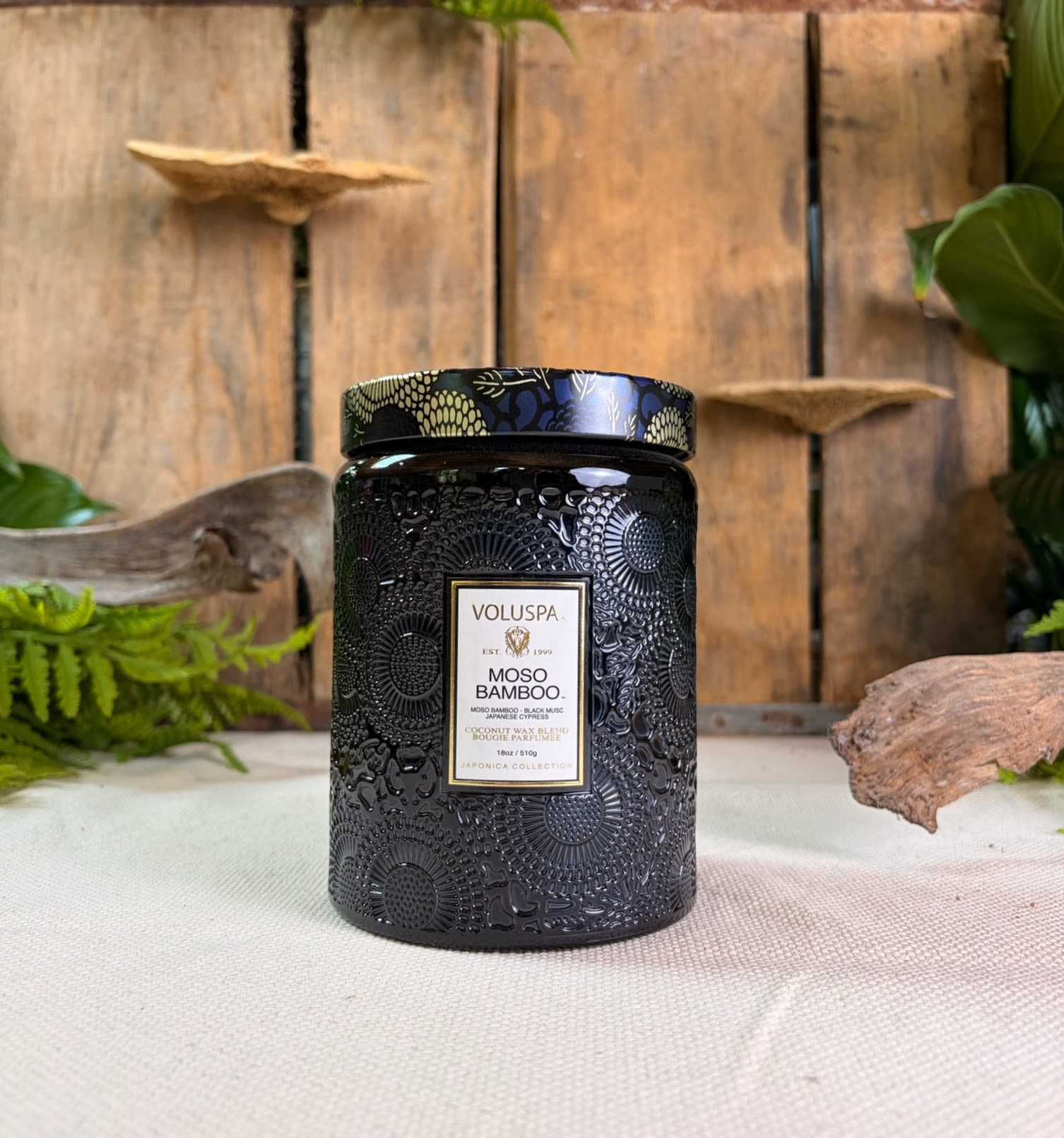 Voluspa Moso Bamboo Large Glass Jar Candle 18 oz - Voluspa Moso Bamboo Large Glass Jar Candle 18 oz  Fragrance Notes: Roam a woodland trail and light a path to the forest, where the scent of the great outdoors thrives with huckleberry vines amid tall Japanese cypress boughs. Lush, green thickets flourish in fertile, dark, musky soil, while fresh bamboo saplings blend with strong, tall reeds, interwoven with greenery. 