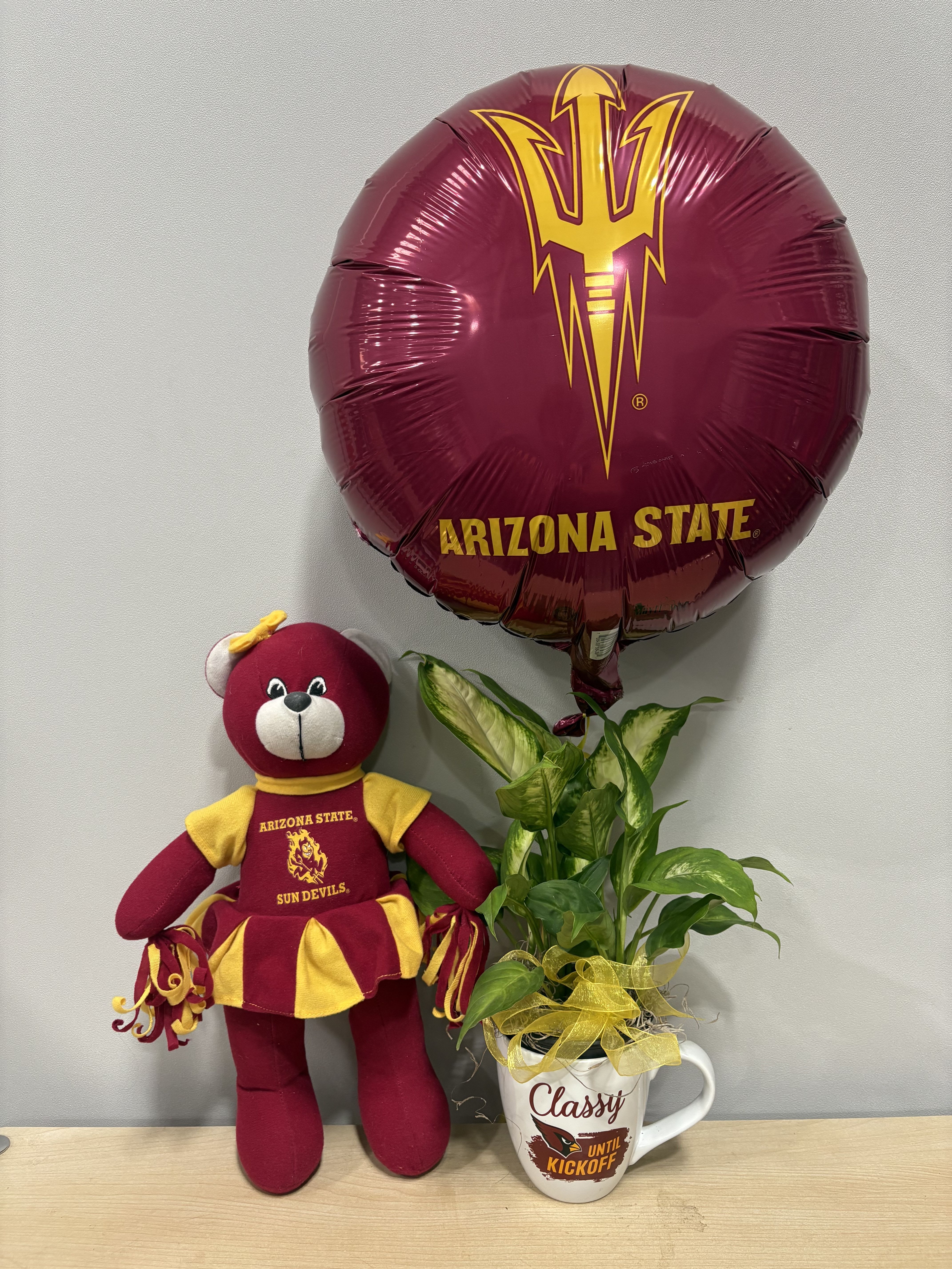Arizona State balloon, teddy bear, and potted plant in a mug