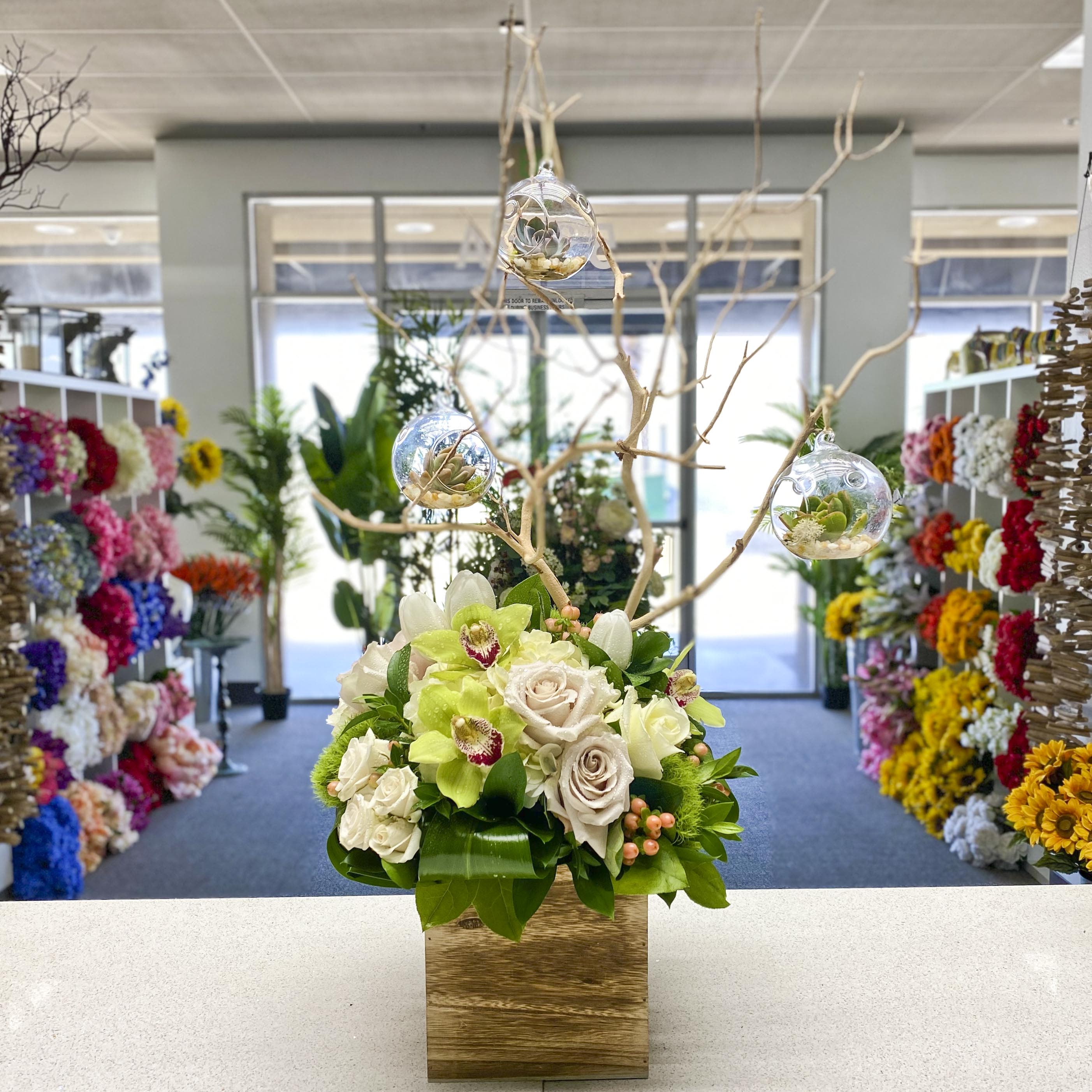 Manzanita of Love – Cymbidium Orchid Centerpiece with Hanging Glass Globes - Beautiful arrangement comes with manzanita &amp; hanging succulents with lovely roses and cymbidium orchids filled with greenery!!  SKU#7941BR