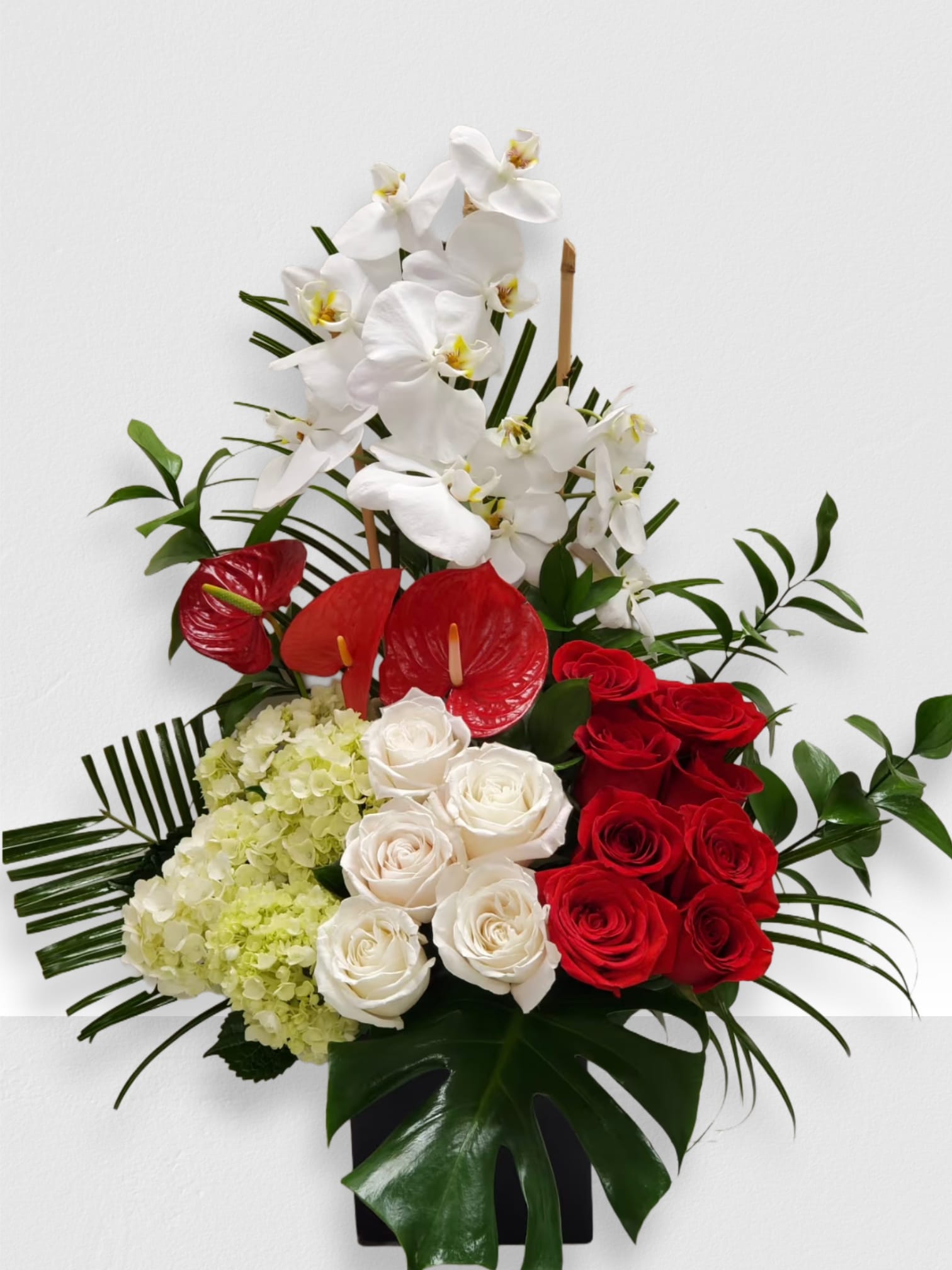 Tropical romance  - Tropical romance is a beautiful romantic arrangement with orchid, roses, hydrangea and beautiful Tropical leaves 
