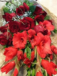 Bouquet of red roses and red amaryllis with baby's breath