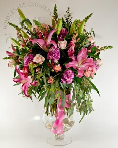 Pink lilies and roses in a clear glass vase