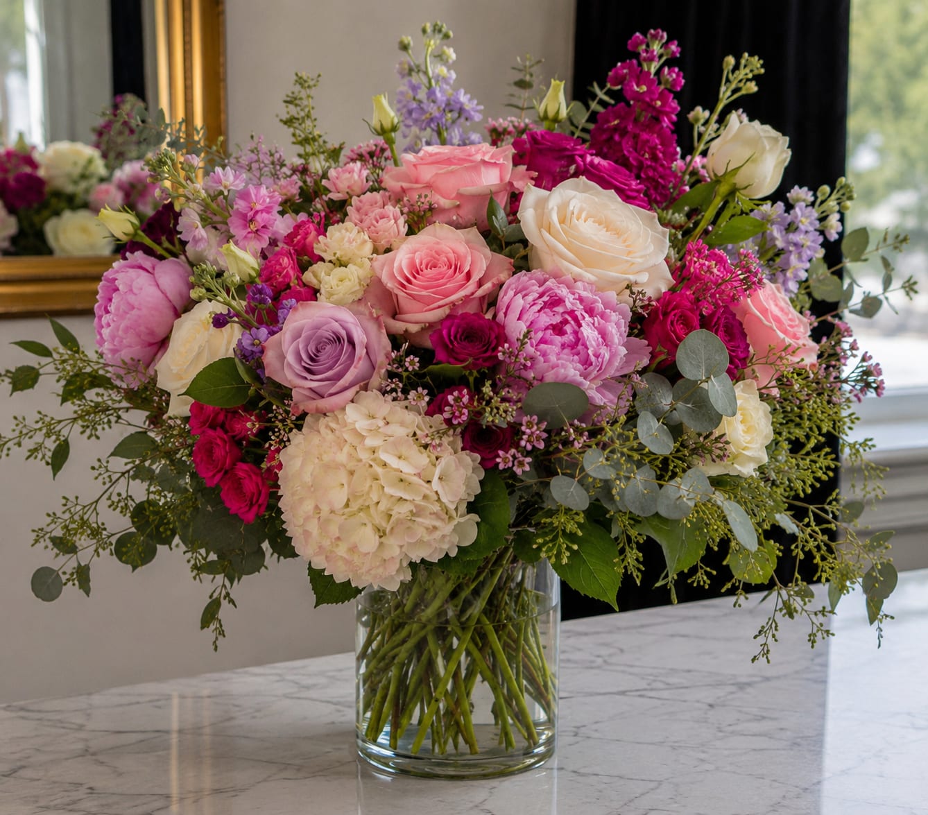 Mixed pink and white flower arrangement in a clear glass vase