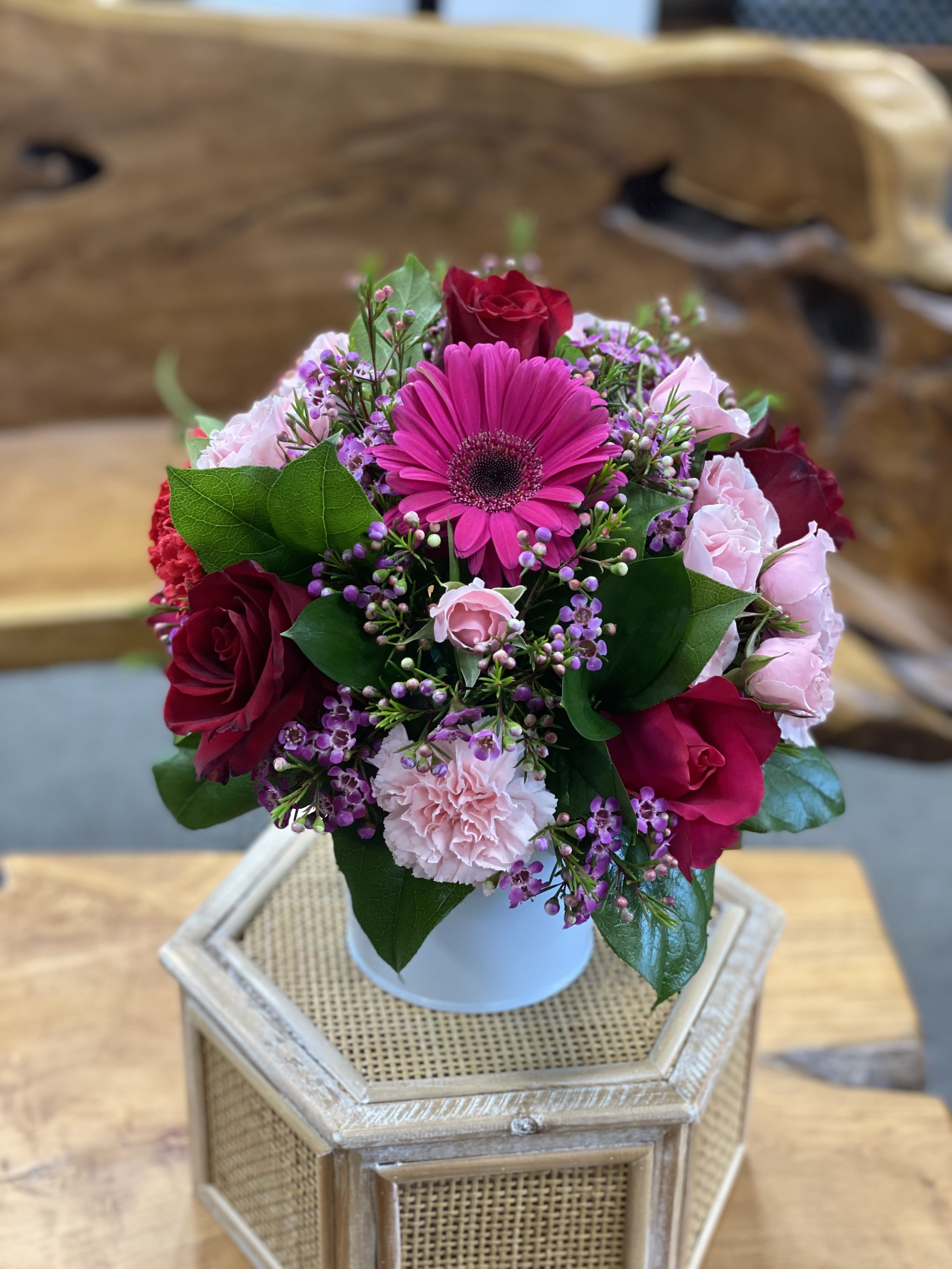Bouquet of pink and red flowers in a white vase