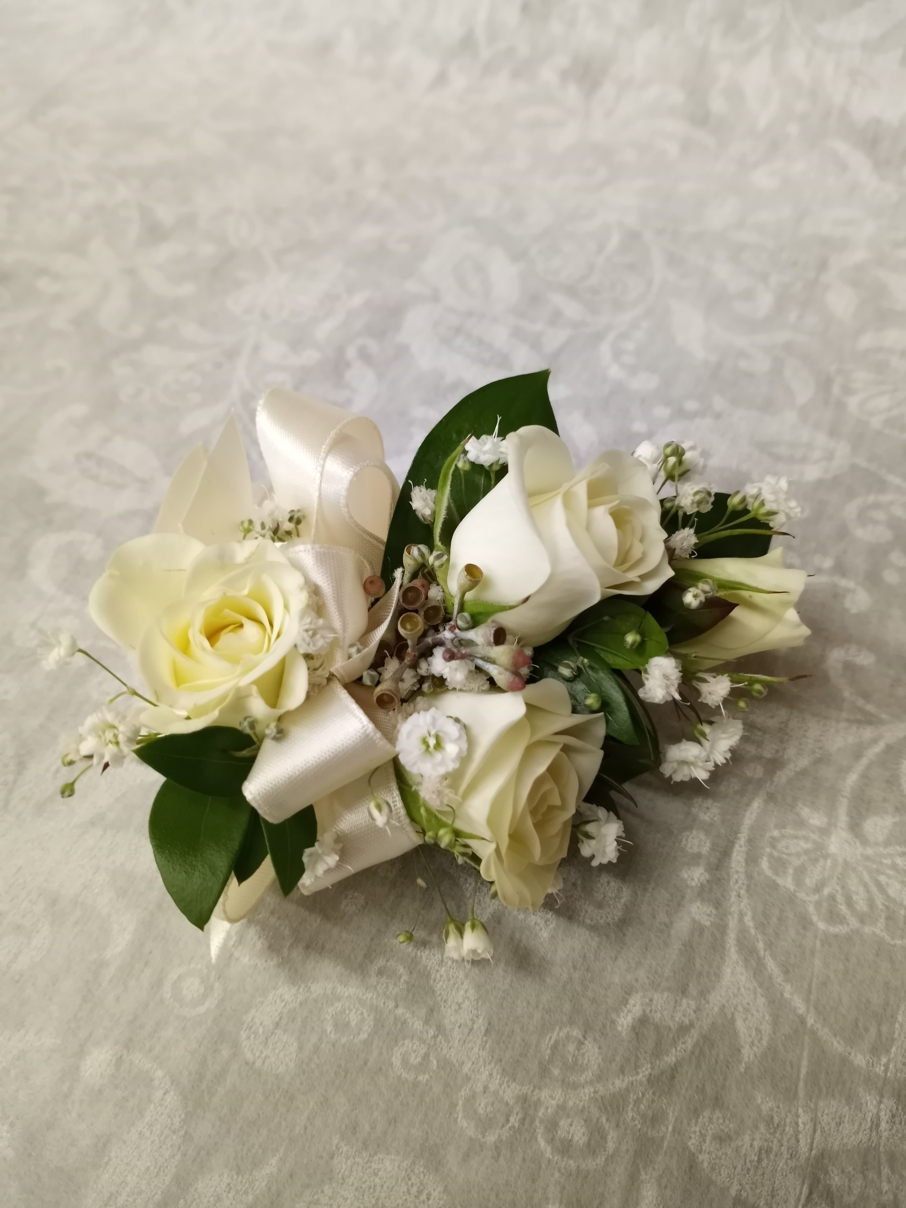 Cream rose bouquet with white ribbon and small white filler flowers