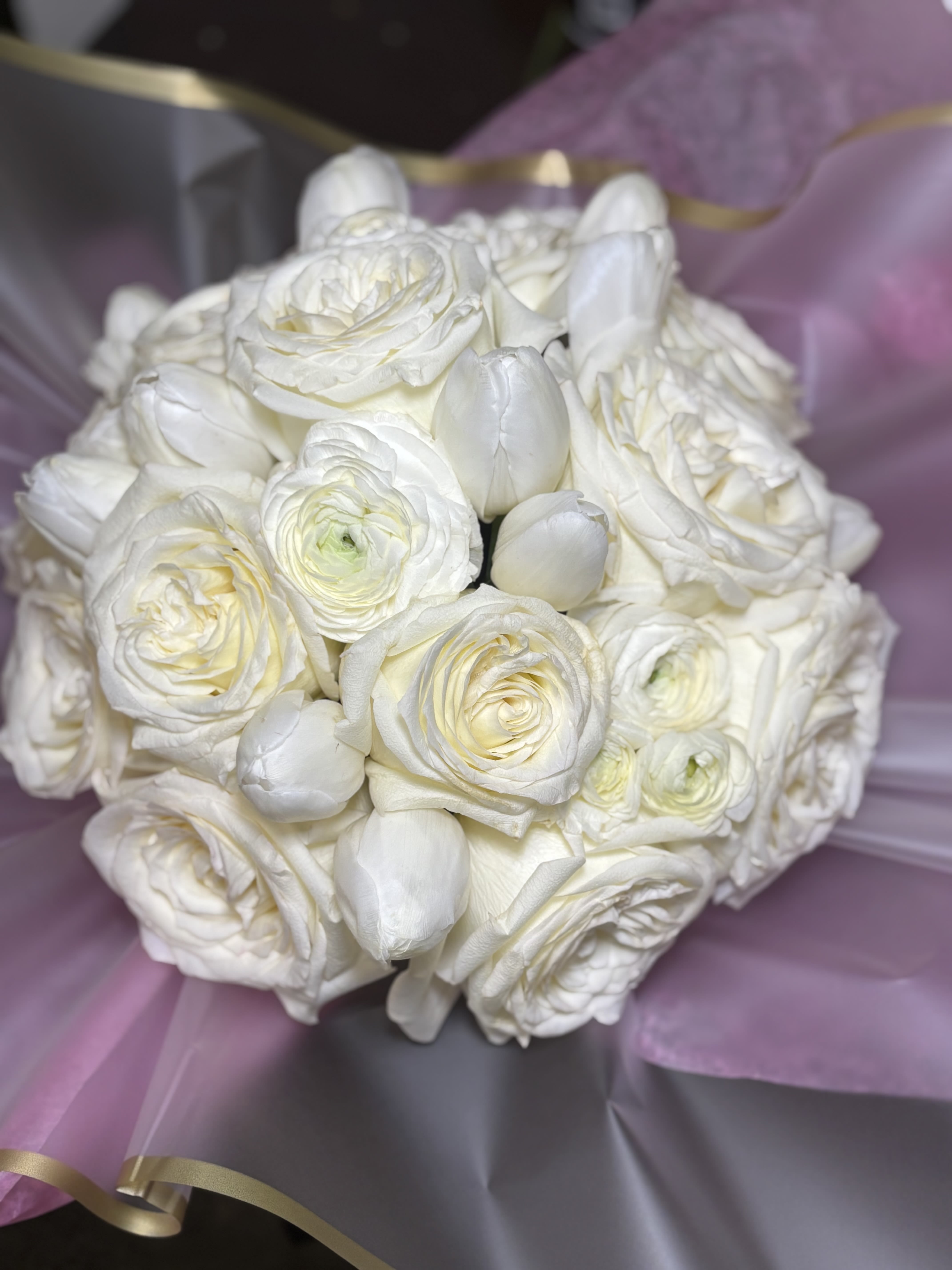 White rose and tulip bouquet wrapped in lavender paper