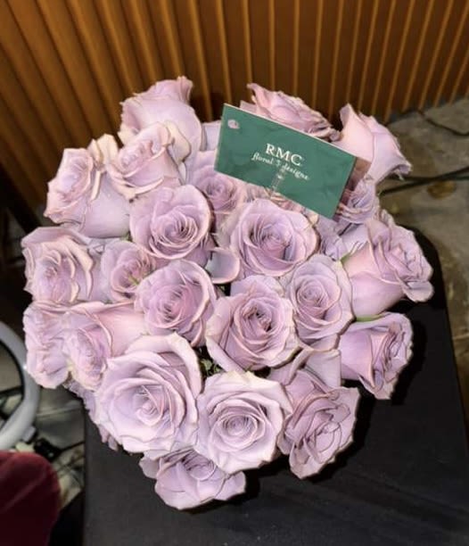 Bouquet of pale lavender roses with a card tucked in front