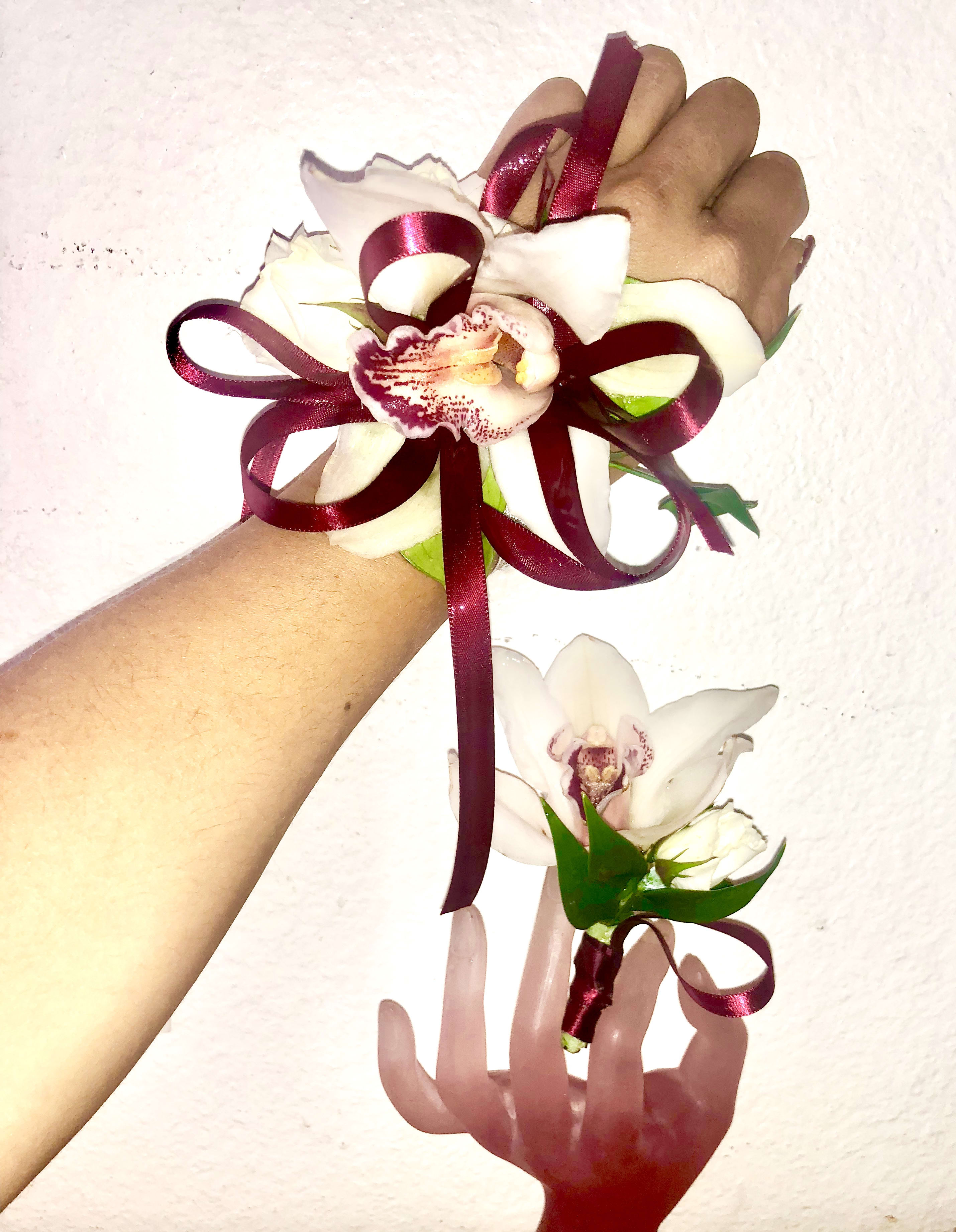 White orchid corsage and boutonniere with burgundy ribbon
