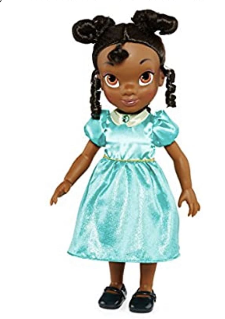 A doll wearing a turquoise dress and black shoes