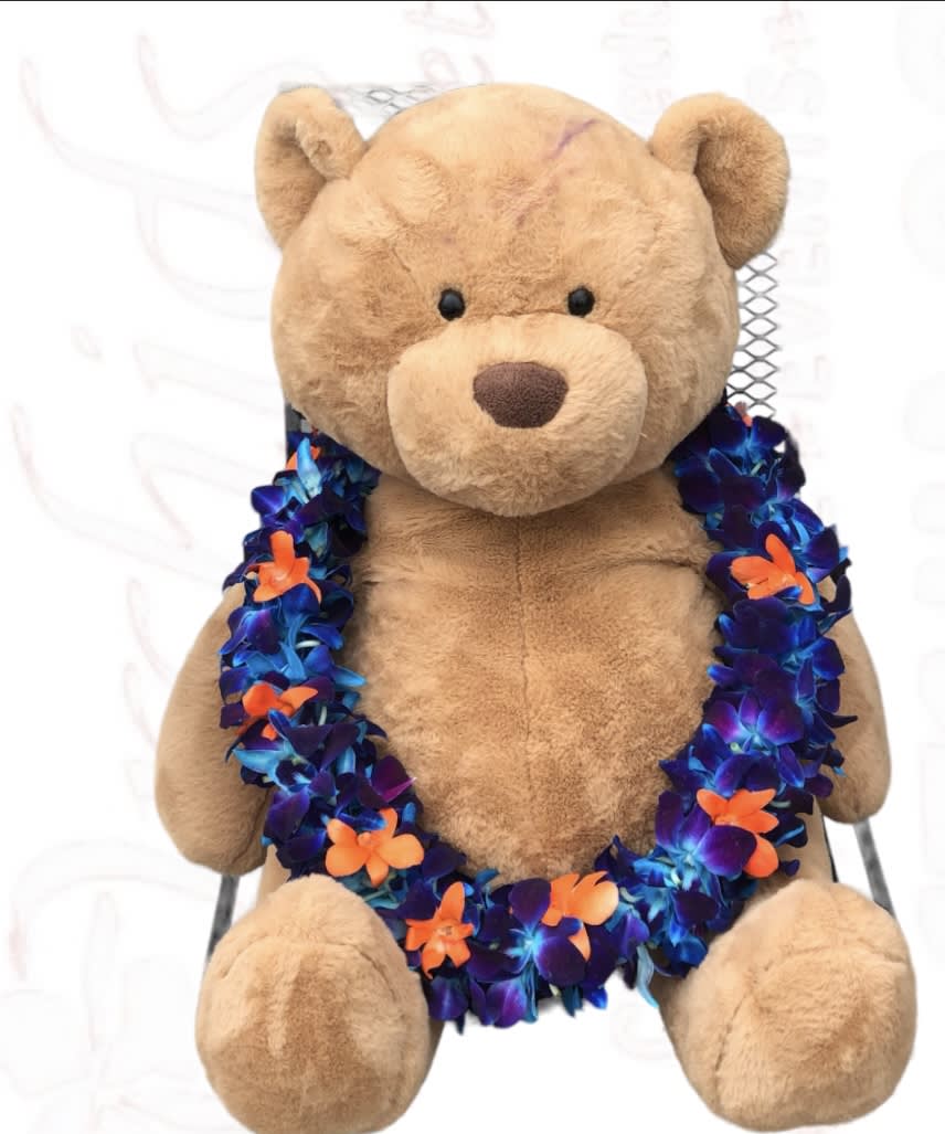 Plush teddy bear wearing a colorful flower lei