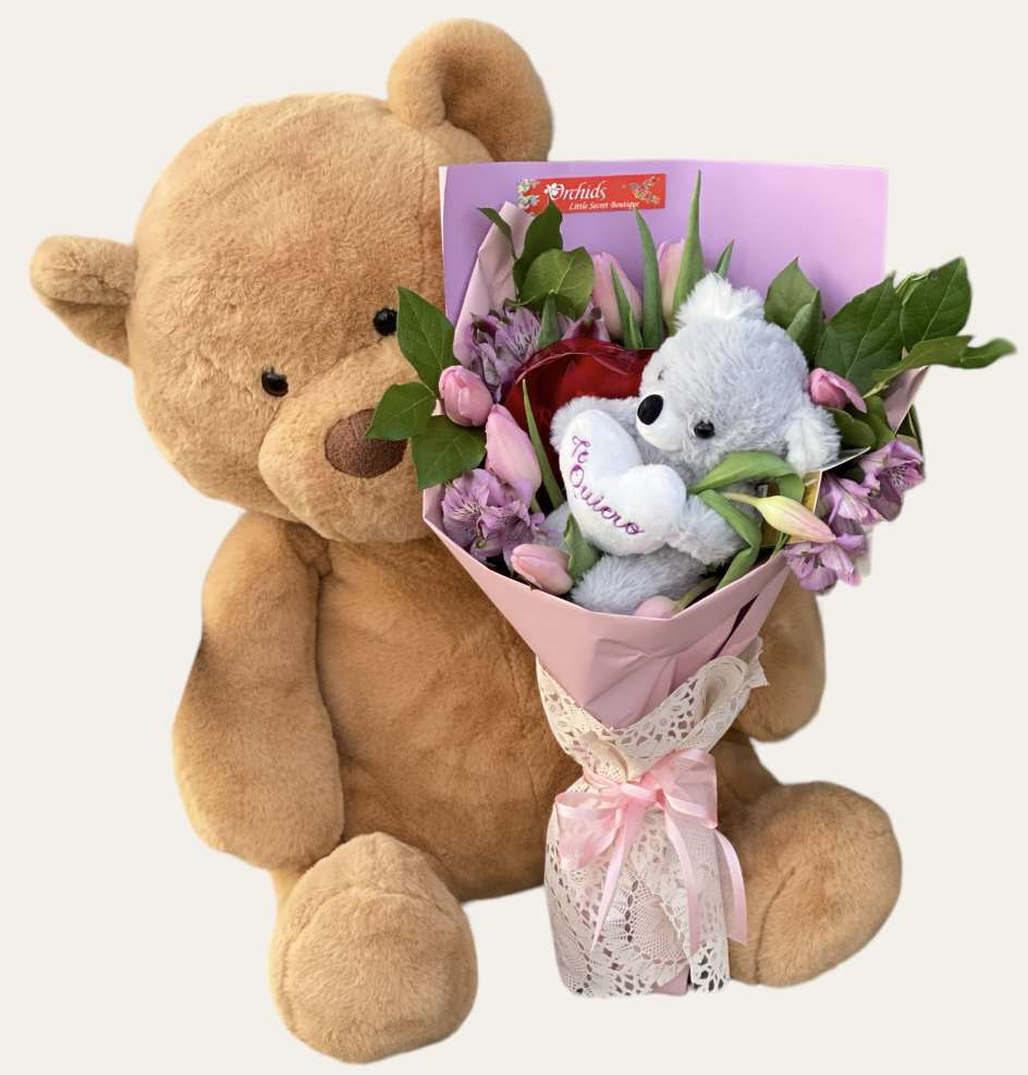 Teddy bear holding a pink bouquet with a small plush bear