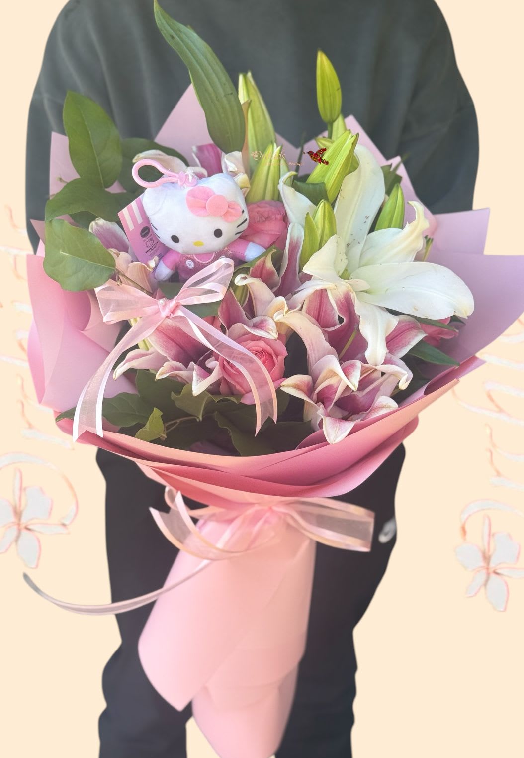Pink and white lily bouquet with a Hello Kitty plush and ribbon wrap
