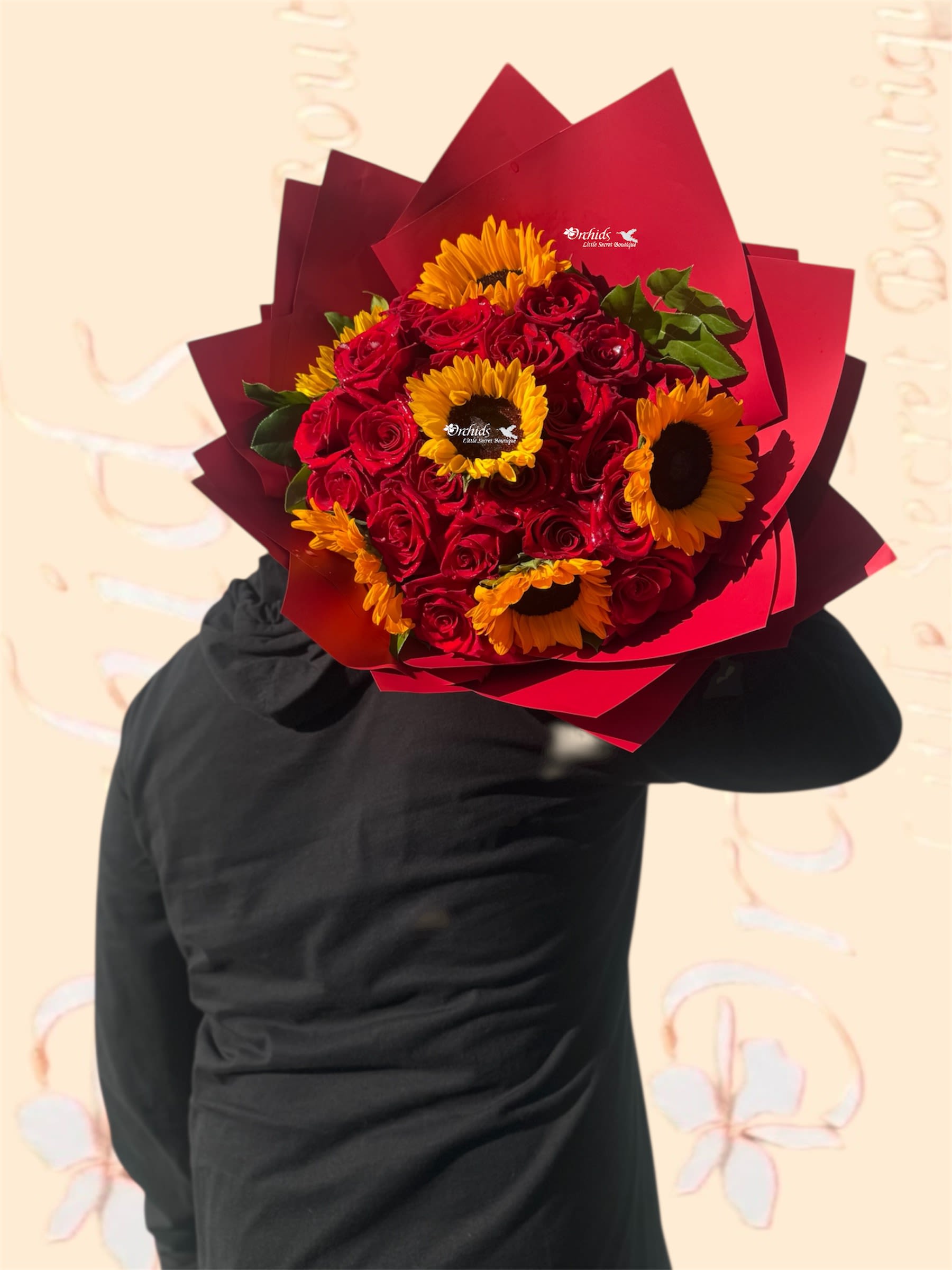 Bouquet of red roses and yellow sunflowers wrapped in red paper