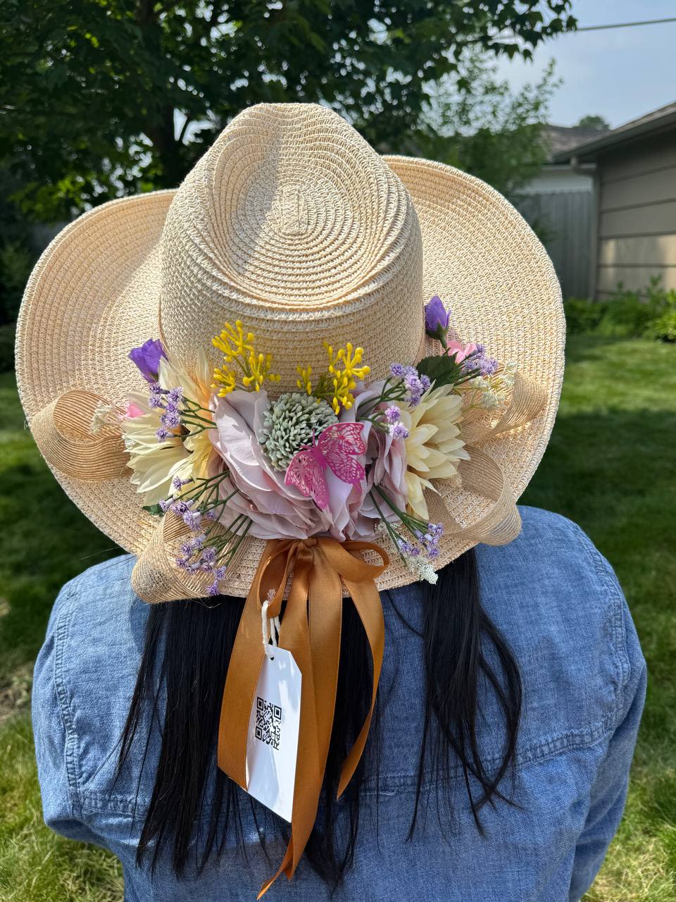 Straw hat decorated with pastel flowers and ribbon