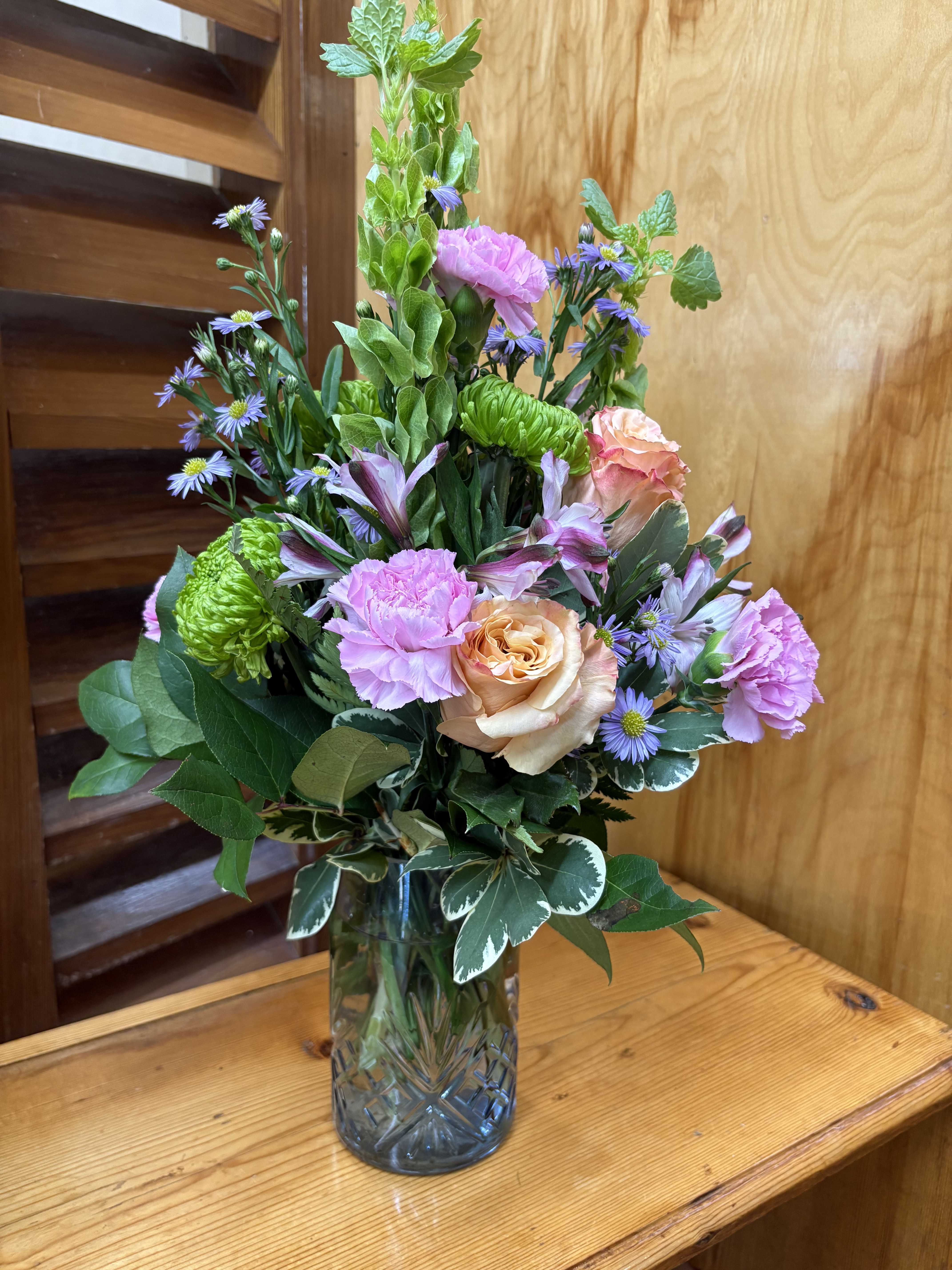 Mixed bouquet in a glass vase with pink and purple flowers