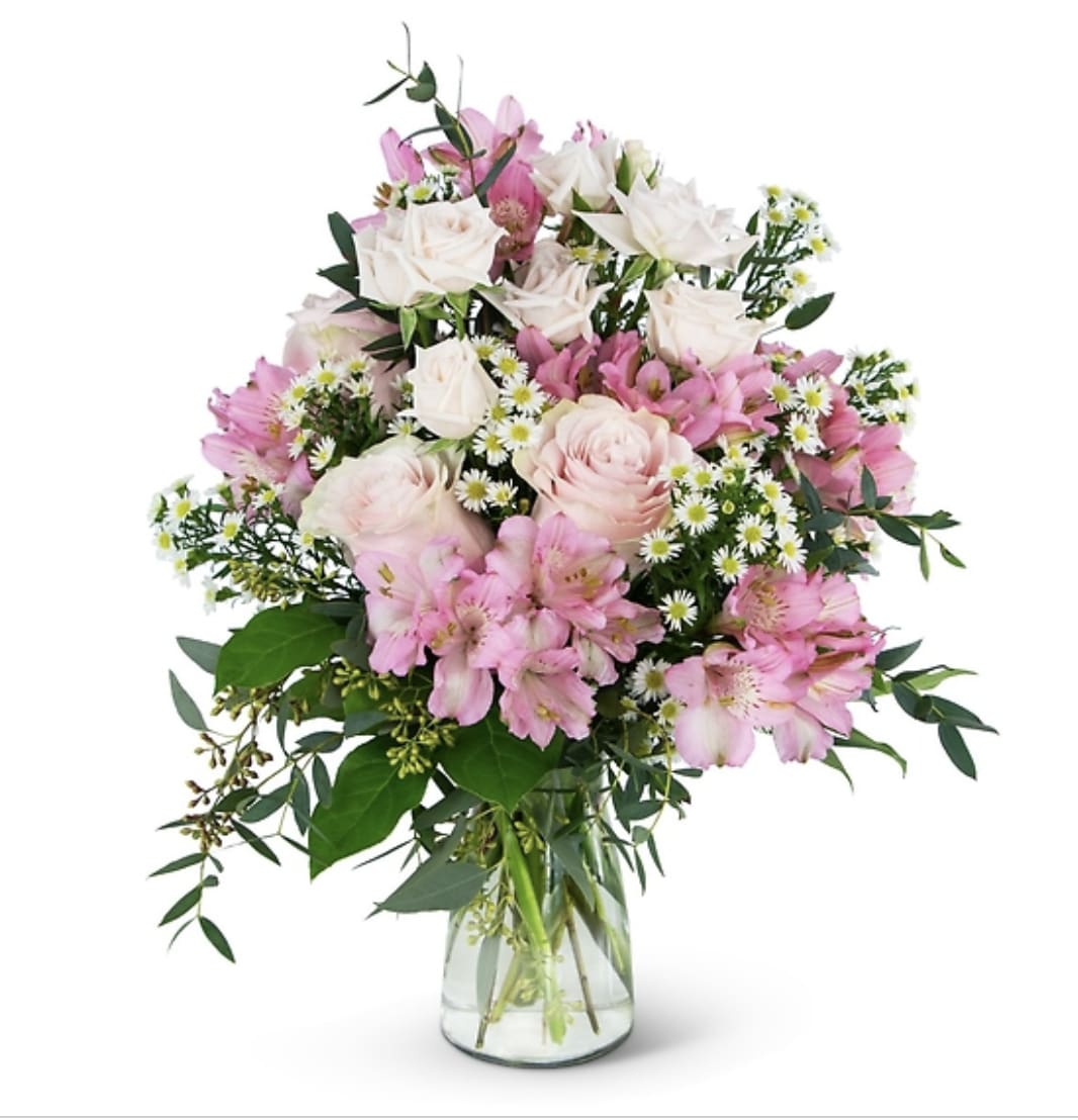 Pink and white mixed flower bouquet in a clear glass vase