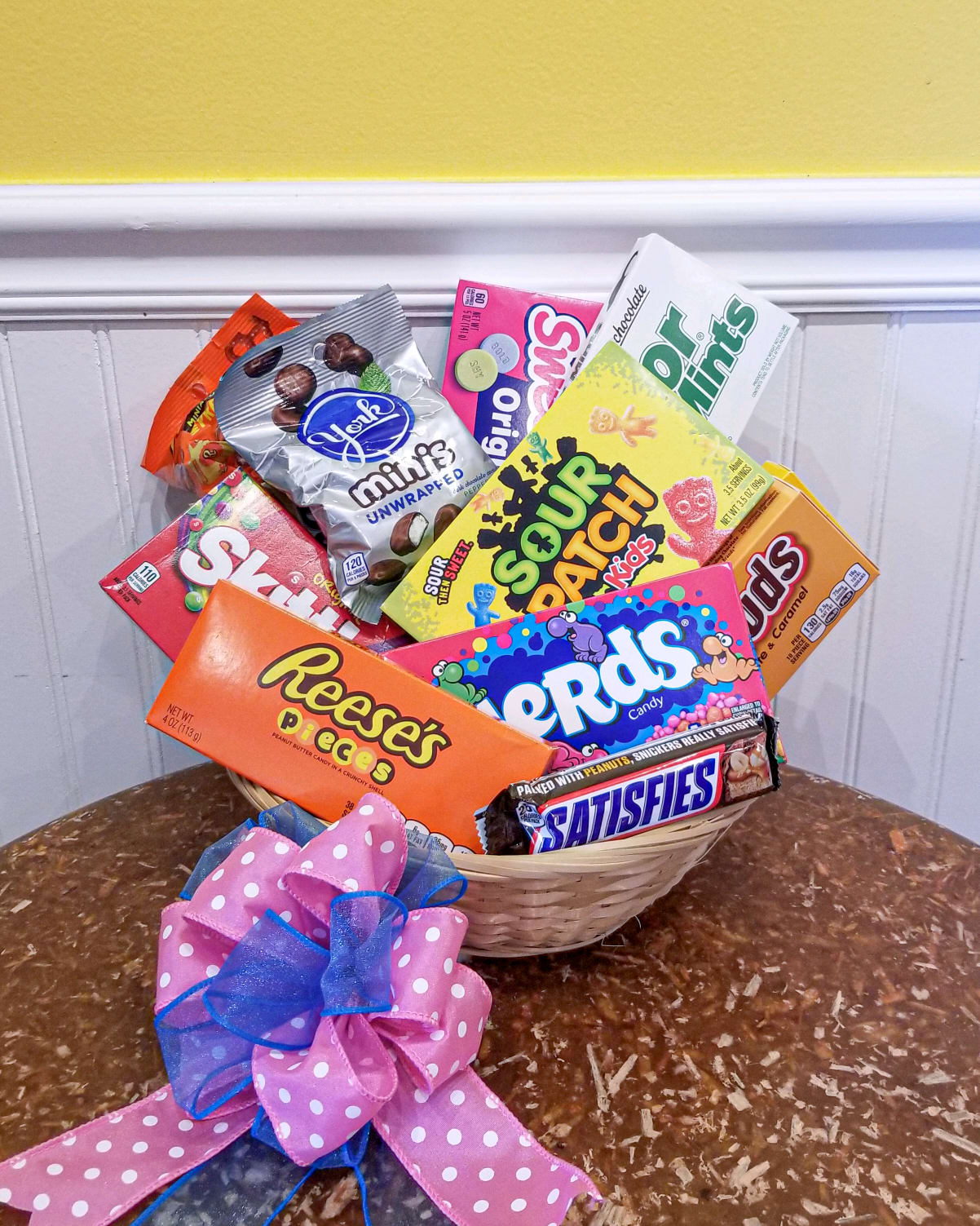 Sweet Tooth Basket - This is the perfect basket to send to someone who loves sweets and savory treats!  Your favorite mixes of hard candies and chocolates in a woven basket wrapped and topped off with a bow. (Some variations of candy may occur based on availability)  