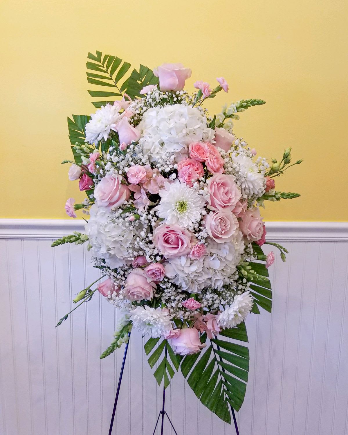 Divine Garden Standing Spray - A tender and classic tribute to a precious life. Heartfelt emotions and sympathies find delicate expression here. Pink and white flowers artistically designed.