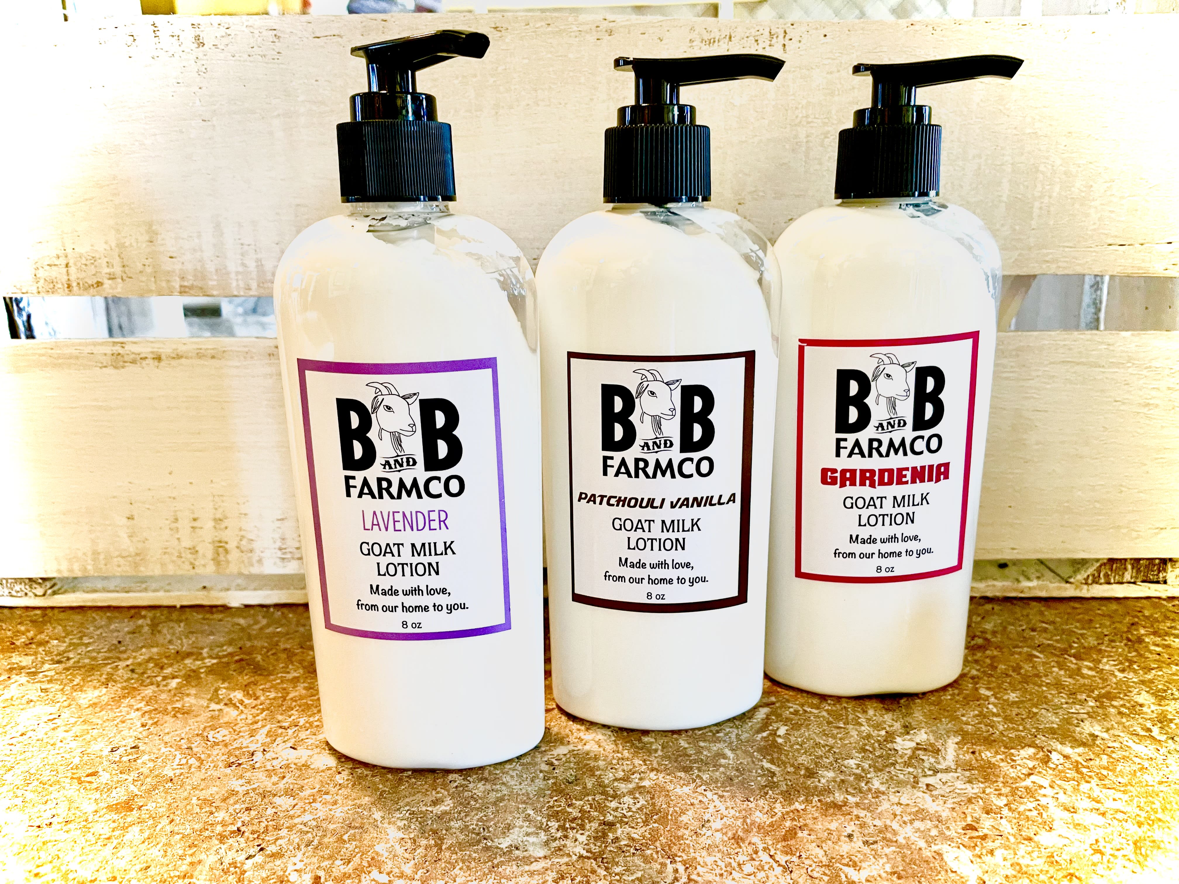 Three bottles of goat milk lotion with pump tops