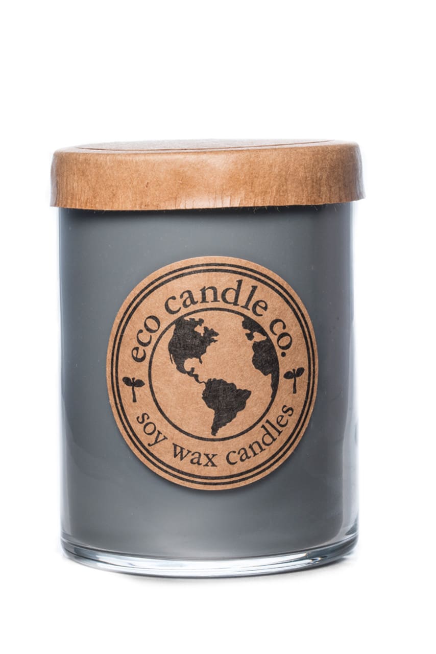 Gray candle in a glass jar with a wooden lid and round label