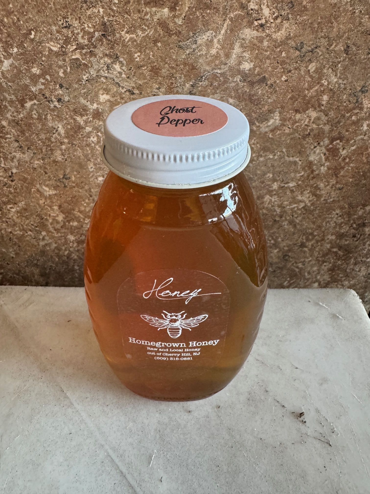 Ghost Pepper Flavored Honey from Homegrown Honey - Raw local wildflower honey that is never heated or filtered. From hive to bottle it remains raw and pure with all nutrients, enzymes and pollen- just as the bees intended. 1 pound jar Made right here from our friends in Cherry Hill ! https://njhomegrownhoney.godaddysites.com/