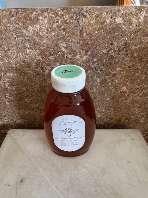 Bottle of honey with a white cap and label