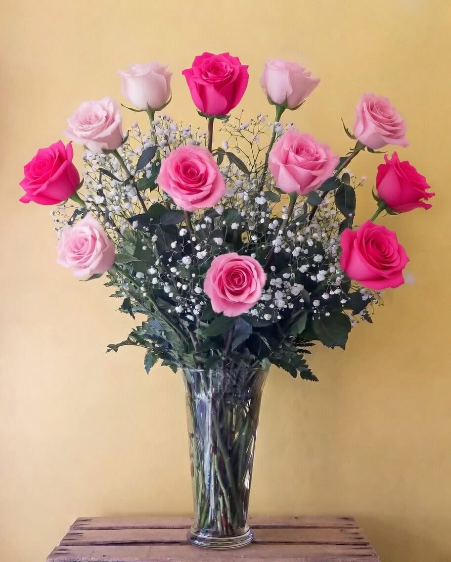 Classic Dozen Mixed Pink Roses - These dozen roses with baby's breath are classic! Perfect romantic gift for Valentine's Day or an Anniversary.  Roses will come in mixed shades of pinks. If not specified we will use red.  Standard: One dozen roses Approximately 16" W x 20" H  Deluxe: Eighteen roses Approximately 18" W x 22" H  Premium: Two dozen roses Approximately 20" W x 22" H 