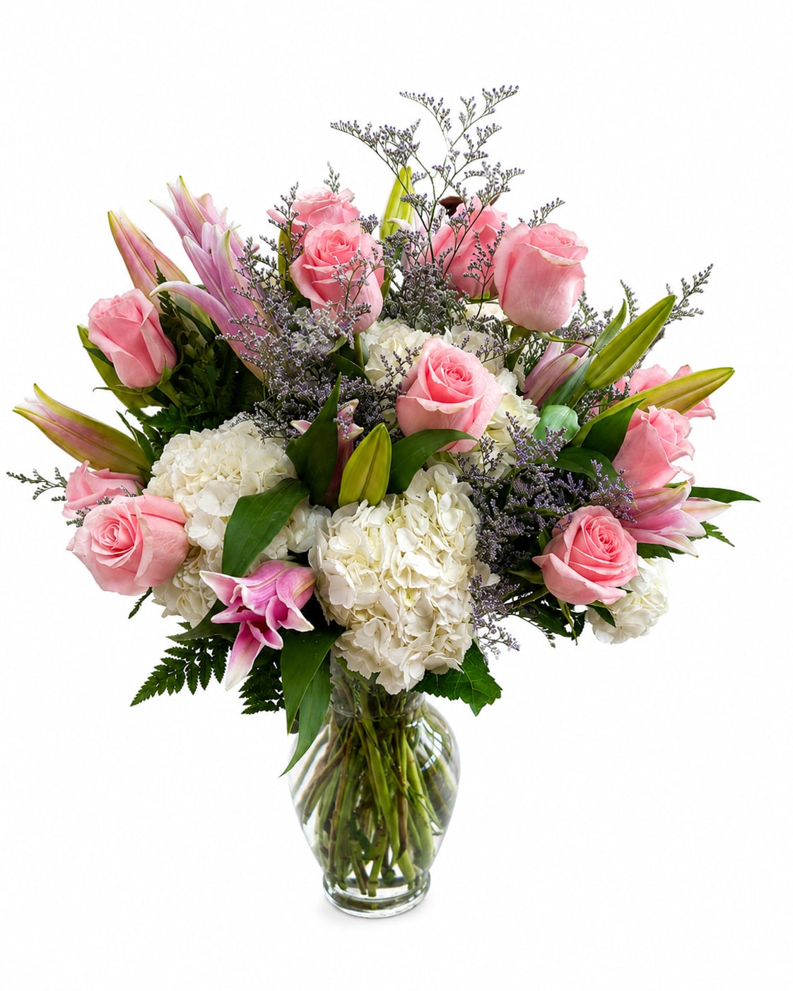 Pink roses and white hydrangeas arranged in a clear glass vase