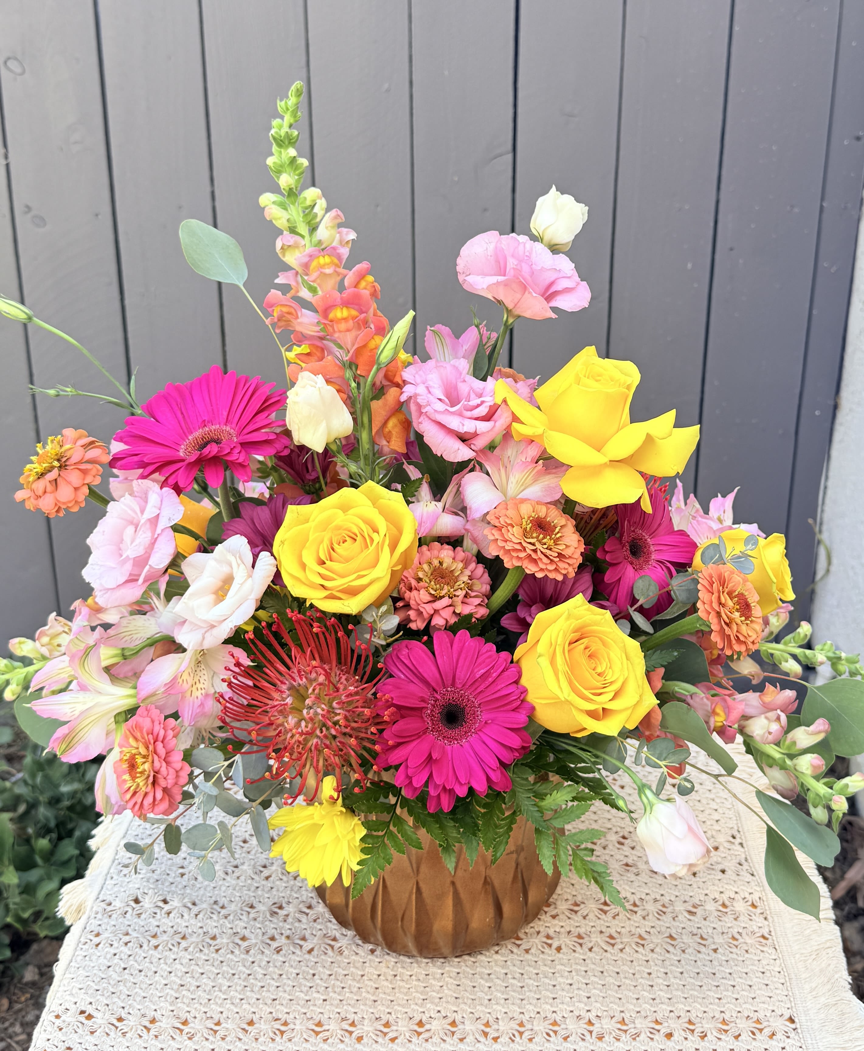 “ A Happy Summer “ Beautiful flower arrangement  - Brighten someone’s day with this gorgeous floral design crafted with Ecuadorian roses, fancy alstroemerias, elegant lisianthus, gerberas, seasonal zinnias, pompom daisies, tropical pincushions, snapdragons and seasonal foliage. It includes a ceramic vase in gold color. Medium size Garden style  Some flowers may vary depending on season and availability. Recipient always receives beautiful fresh blooms. Share joy with flowers   