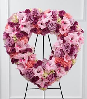  Eternal Rest - (Standing Easel Heart) - The FTD® Eternal Rest™ Standing Heart bursts with love and sweet comfort to honor the deceased at their final farewell service. Lavender roses, pink carnations, purple button poms, lavender chrysanthemums, pink gladiolus and pink hydrangea are beautifully arranged in the shape of a heart and displayed on a wire easel to create a stunning display of warm affection that will last in the hearts of friends and family for years to come. Approximately 22-inches in diameter. Your purchase includes a complimentary personalized gift message.