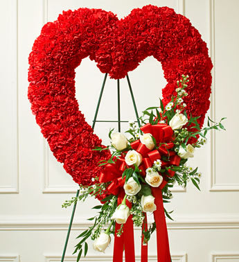 Red and White Open Heart with White Roses -  Product ID: 91242   Send a tribute that reflects your undying love and heartfelt sympathy. Flowers such as white roses, red carnations and more Open heart with oasis in mache, tied to the wire easel with satin ribbon Sent directly to the funeral home by family and friends Due to the sensitivity of the occasion, our florists use only the freshest flowers available so components may vary Measures approximately 26"H x 28"D