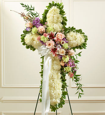  Pastel Peace and Prayers Cross (Easel Stand) - This beautiful floral tribute shows your compassion, faith and love during this difficult time. This standing spray arrangement â in the shape of a cross â is created from fresh white mums and pastel-colored roses, lilies, stock, lisianthus, carnations and more Traditionally sent directly to the funeral home by family members or friends and displayed on a stand Our florists use only the freshest flowers available so varieties and colors may vary Measures approximately 42"H x 28"L without easel