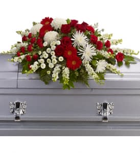 Red and white floral spray on a gray casket
