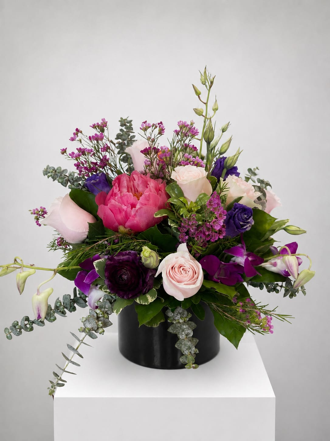 Pink and purple mixed bouquet in a black vase