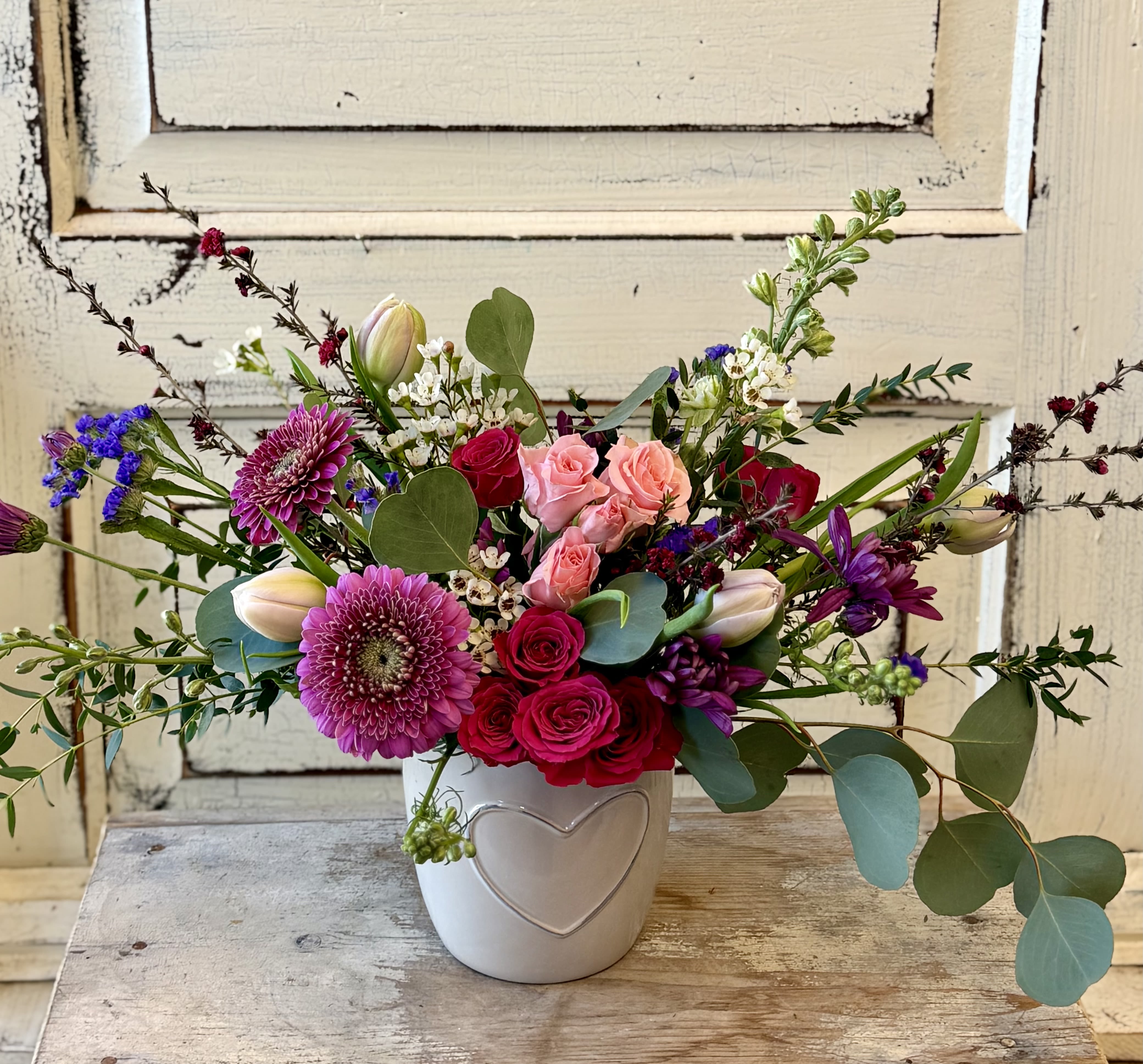 Sending Love - Send your sentiments with this adorable ceramic pot with a subtle heart accent. (The pot comes in either dark or light gray.) A bright assortment of seasonal flowers, unique fillers and foliage make for a gorgeous arrangement. 