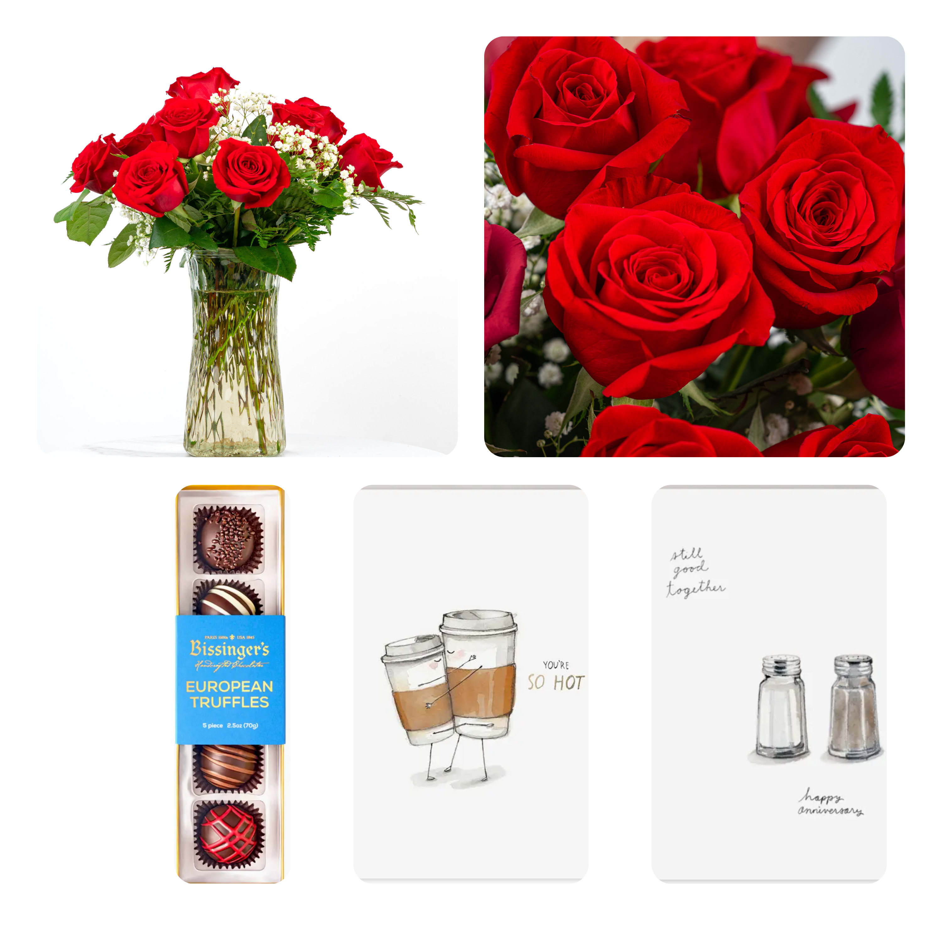 Red roses in a clear glass vase with chocolates and greeting cards nearby.