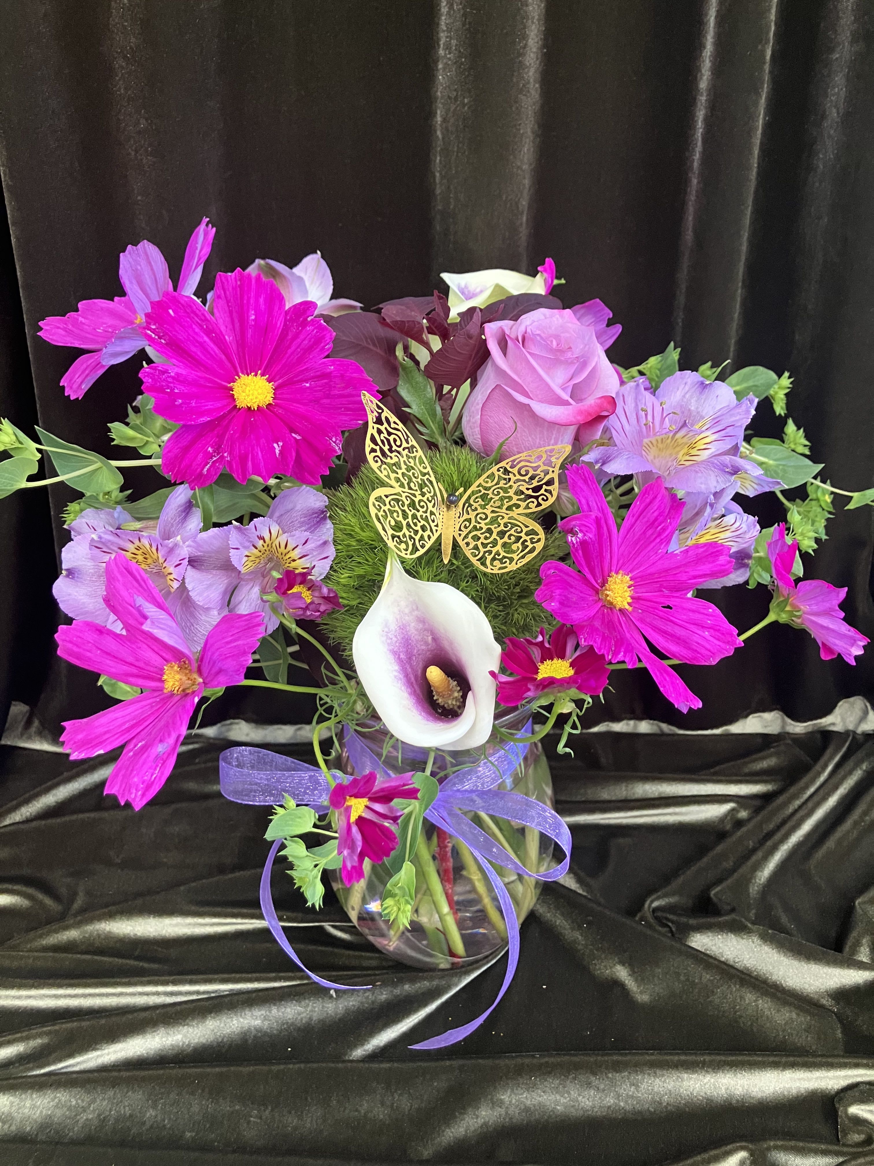 Purple Surprise - One of our best sellers, this fresh flower arrangement includes, cosmos ,  calla lilies, alstroemeria, green dianthus, and a purple rose