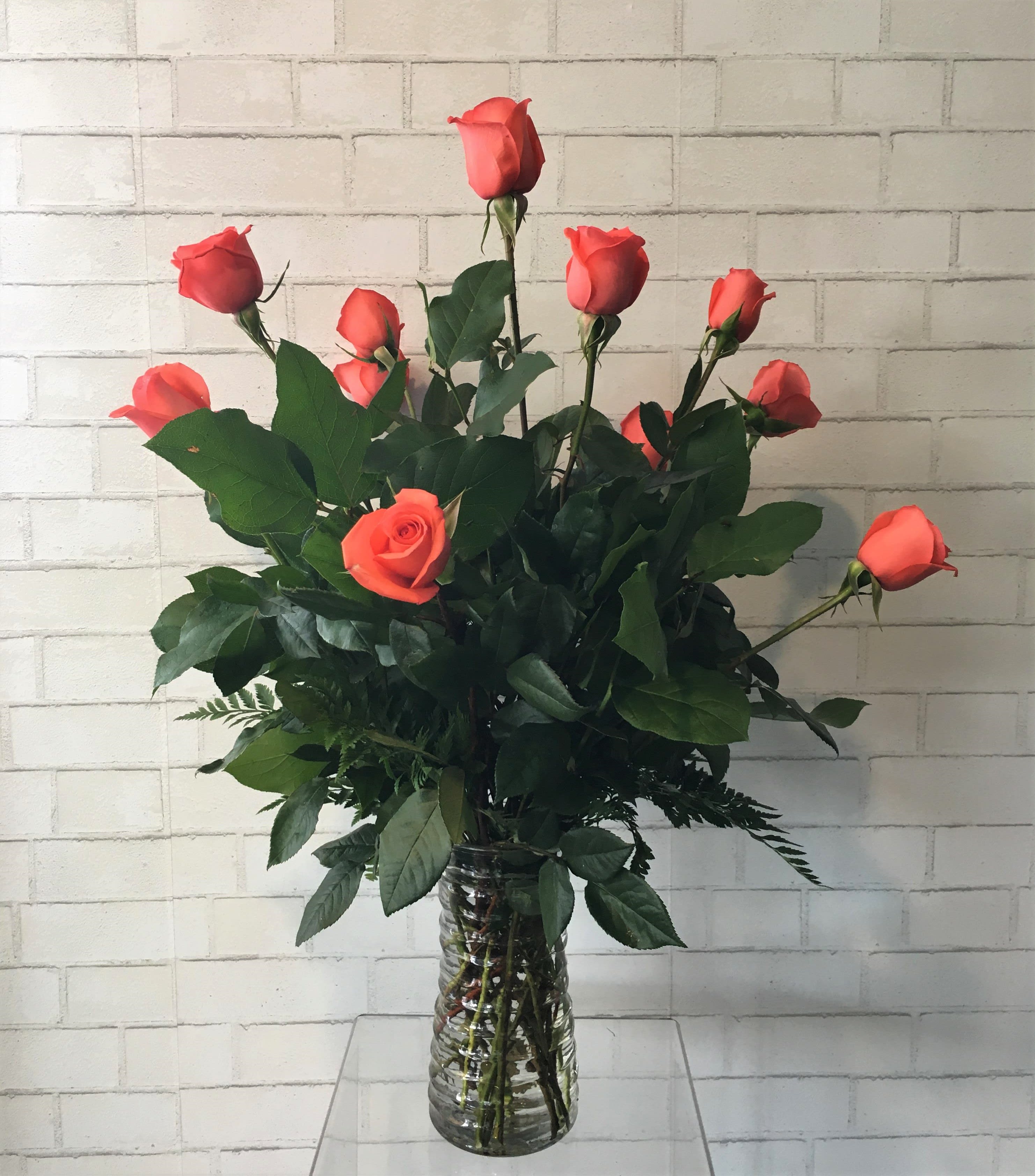 Coral rose bouquet in a clear glass vase