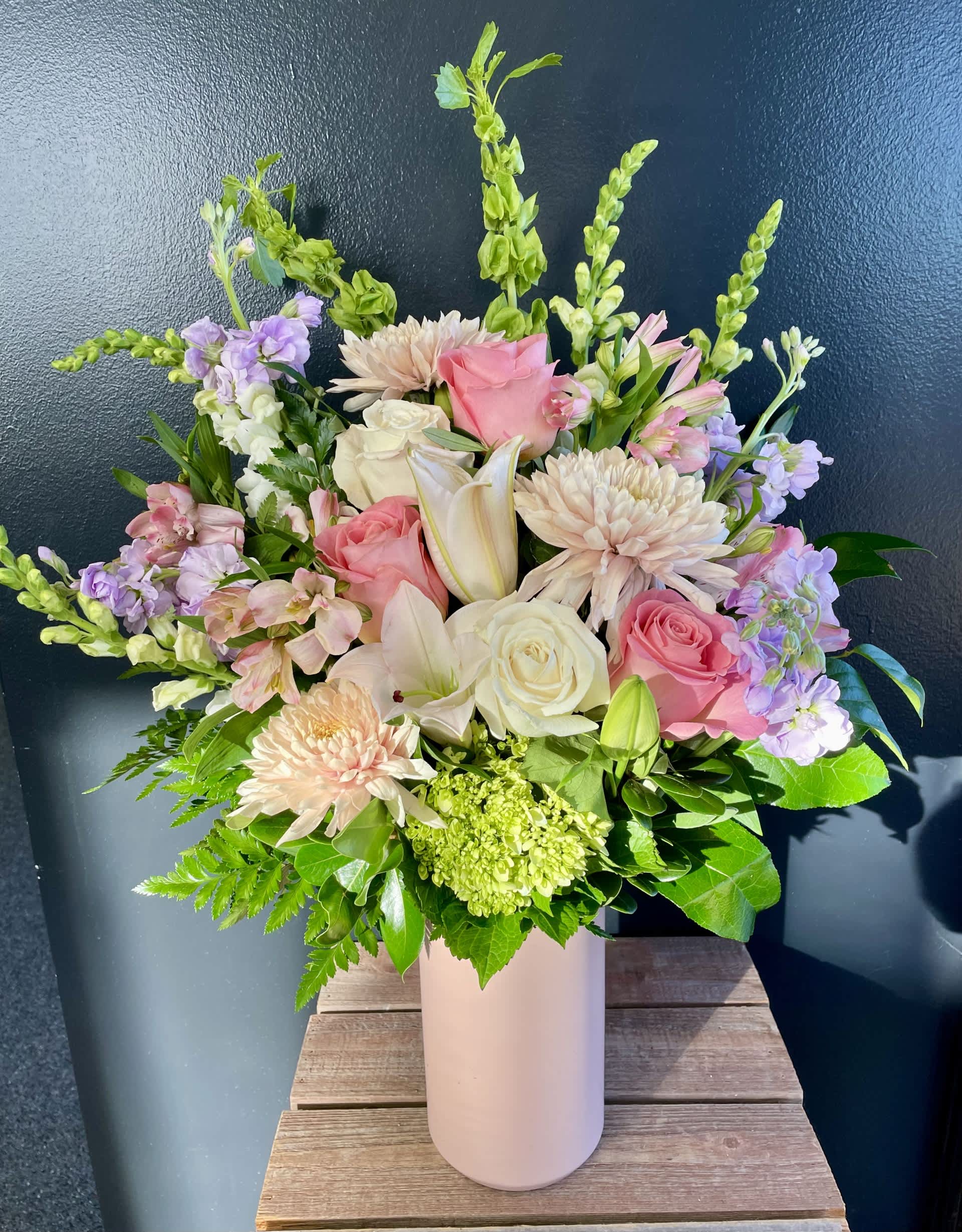 Pink and white mixed bouquet in a tall blush vase