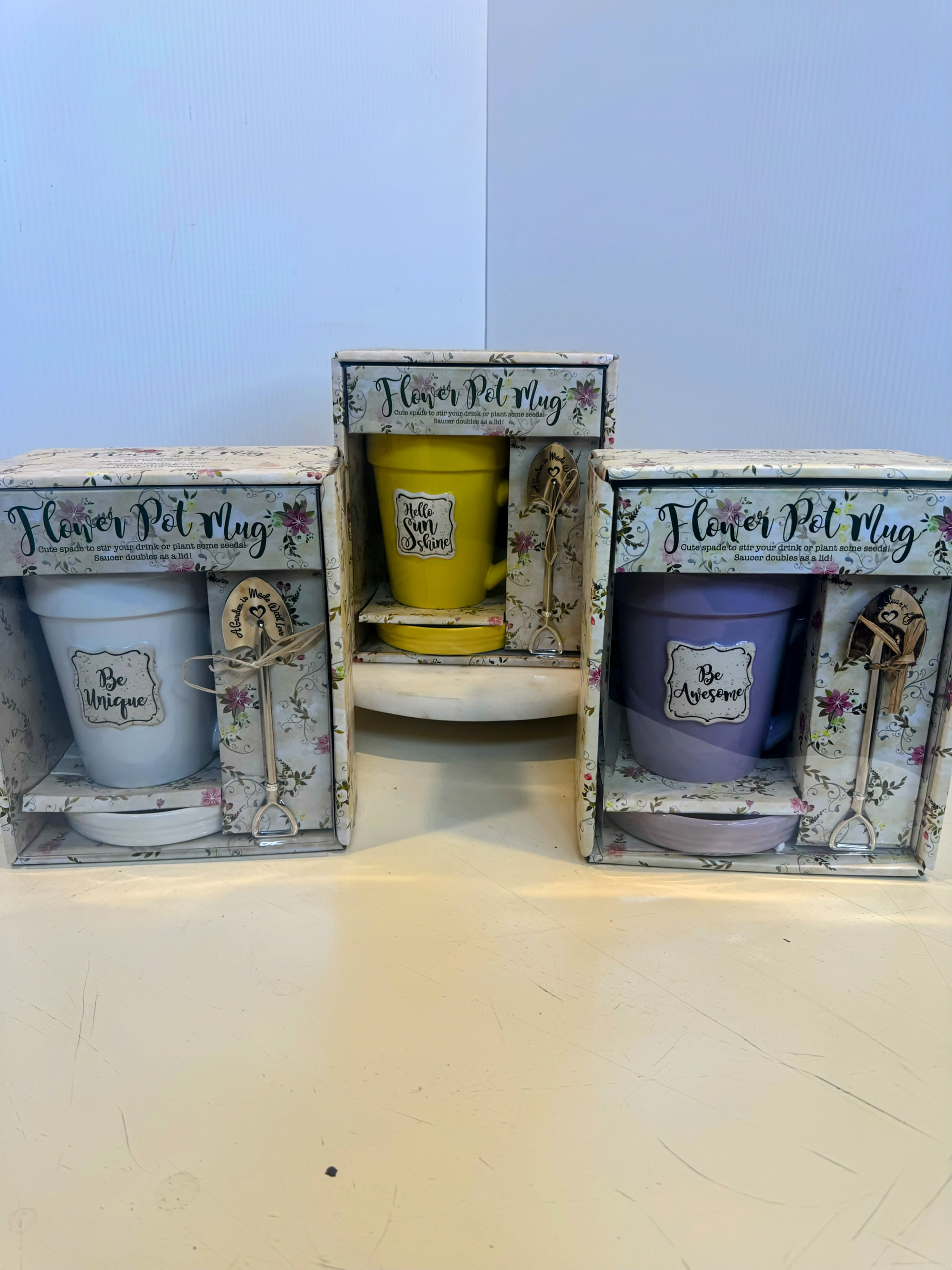 Three boxed flower pot mug gift sets with colorful mugs and matching saucers