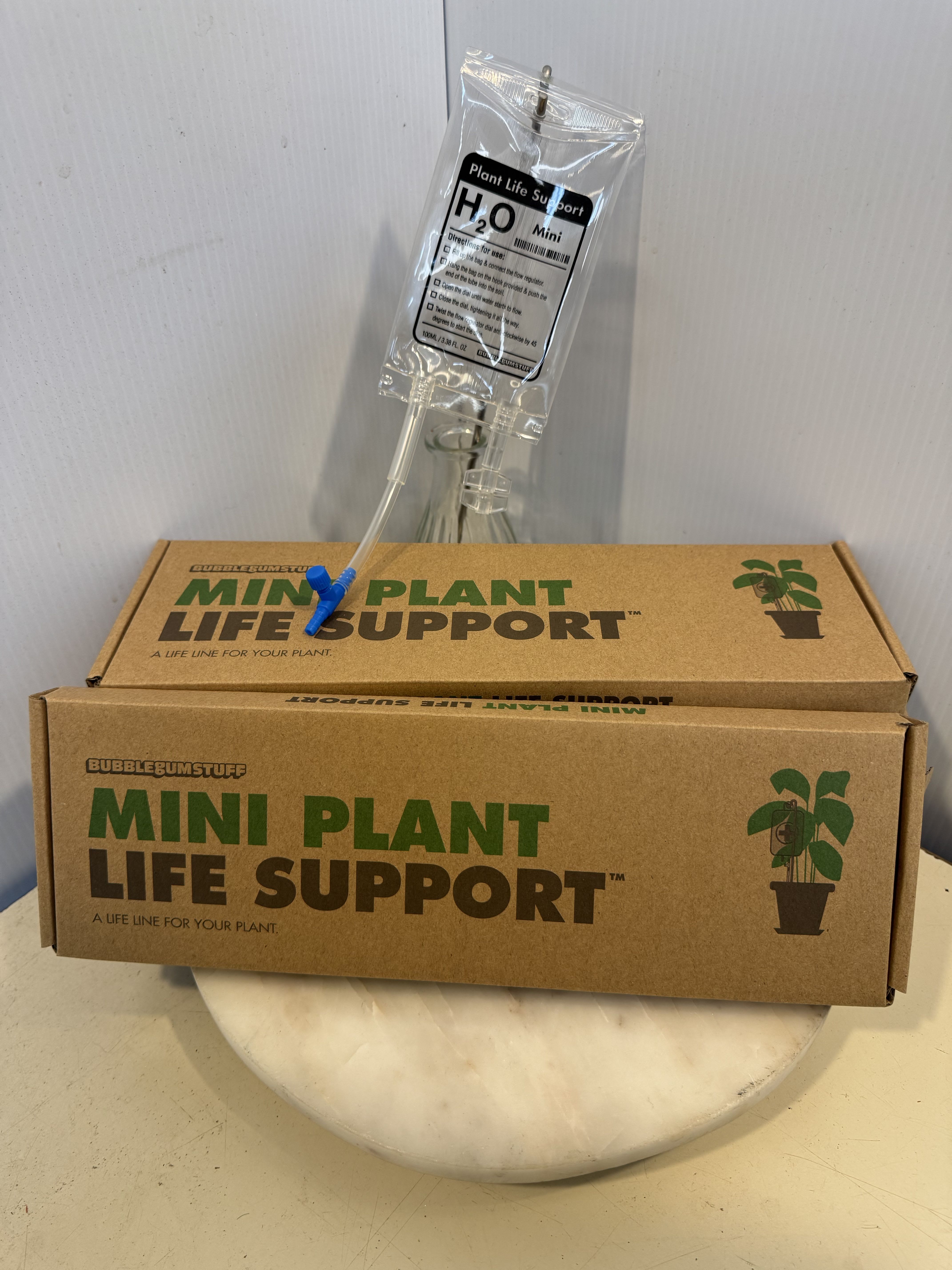 Plant care kit with a clear water pouch and cardboard box