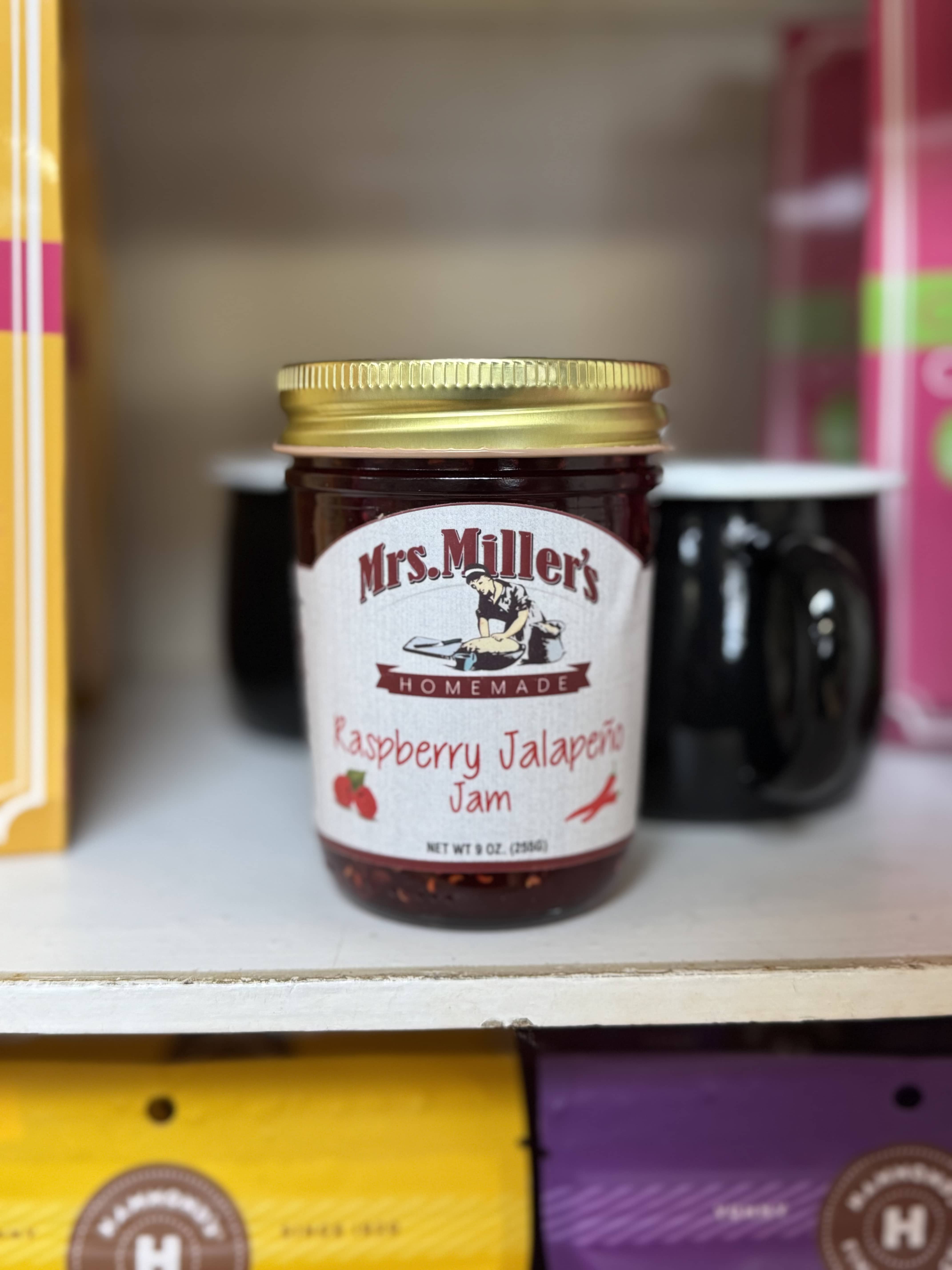 Jar of raspberry jalapeño jam with a gold lid