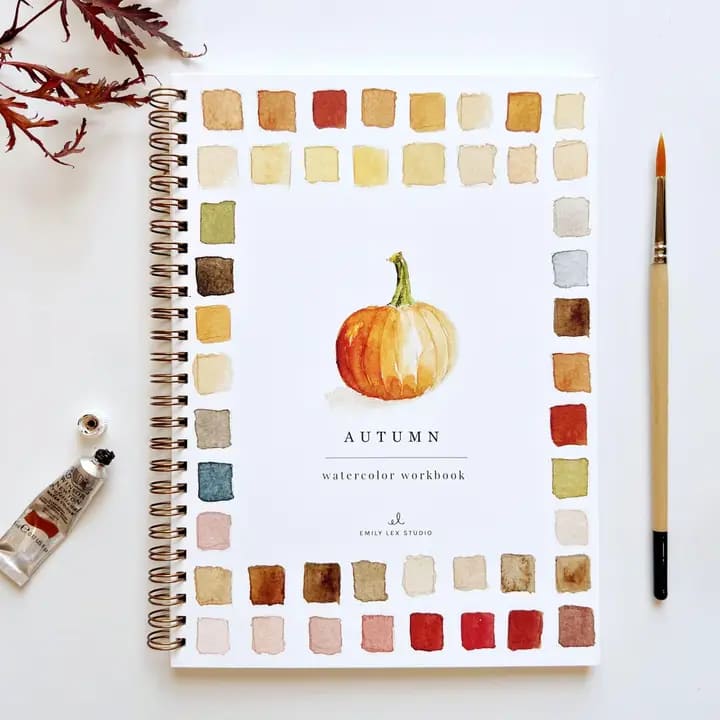 Autumn watercolor workbook with a painted pumpkin on the cover