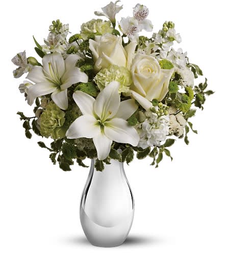 Silver Reflections by Teleflora - Bring a touch of elegance to any special occasion with a mix of lacy white flowers in a dazzling silver vase. This unusual and beautiful gift will be used and appreciated for many years to come.  The gorgeous bouquet includes green and white flowers accented with variegated greenery. Delivered in a graceful ceramic vase with a gleaming silver metallic finish. Bouquet is approximately 14” W X 18” H.