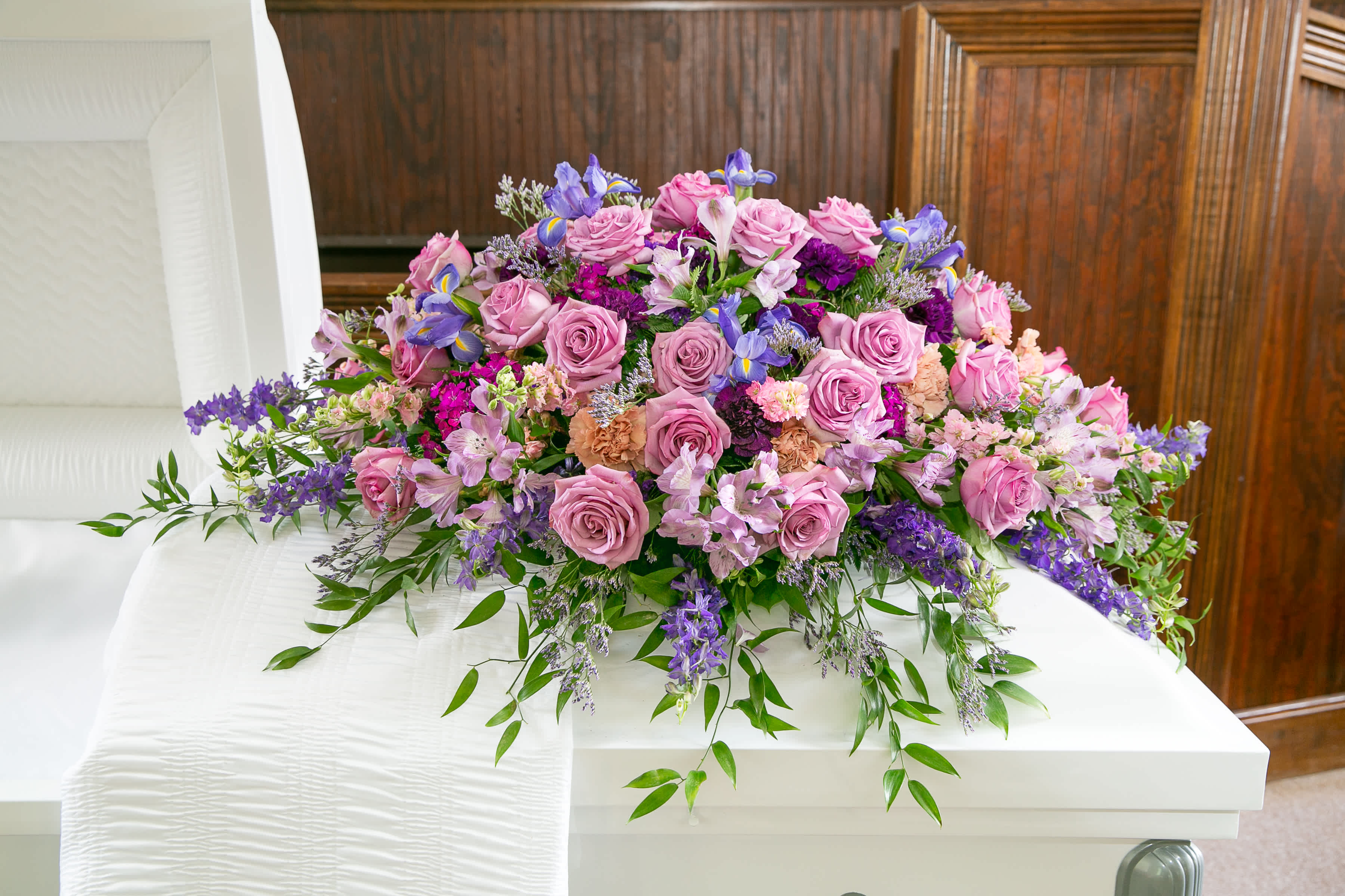 Purple Casket Spray - A beautiful array of lavender and purple flowers designed to rest of top of the caseket.