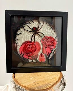 Framed spider decoration with red rose accents