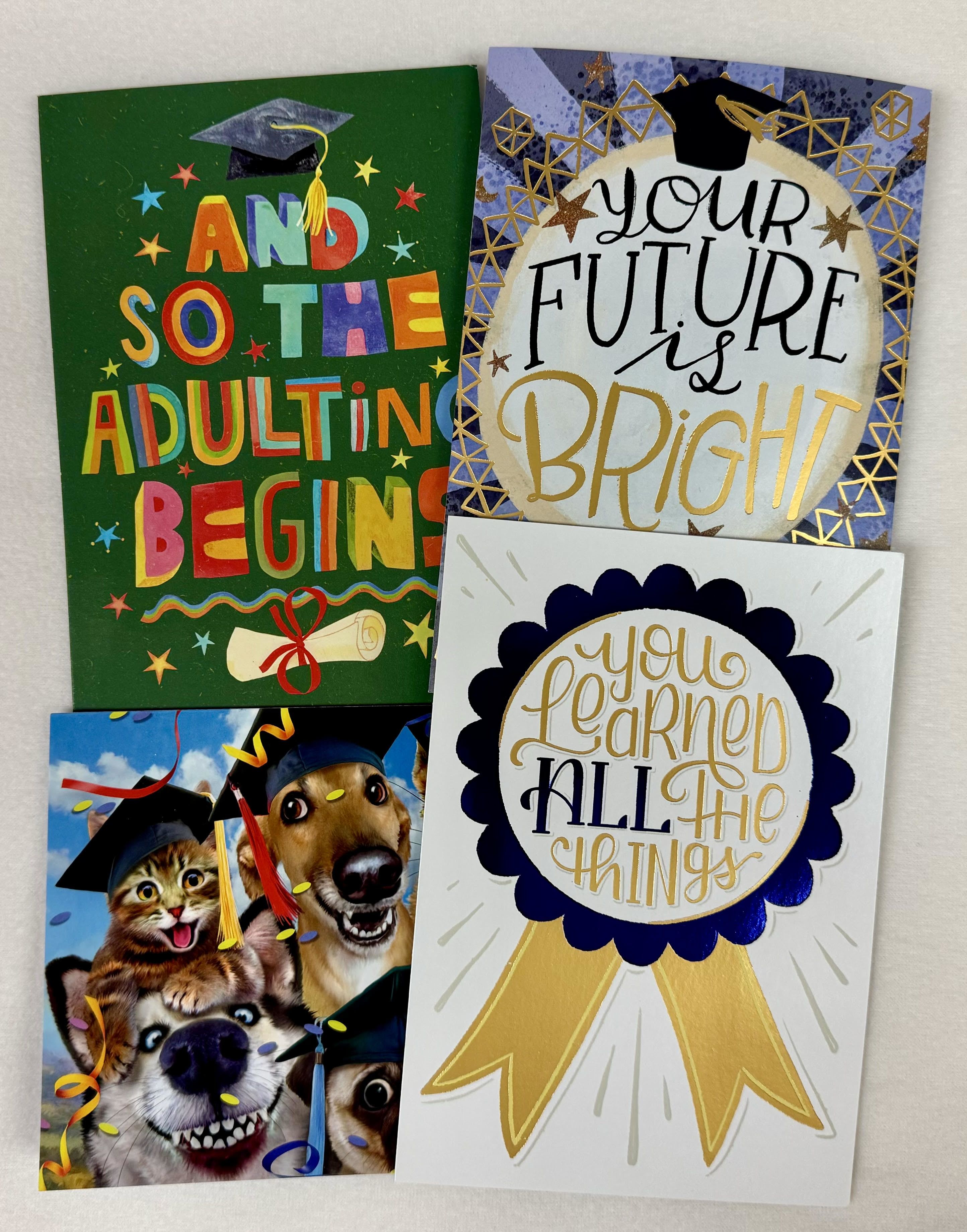 Four graduation-themed greeting cards with caps, ribbons, and celebratory text